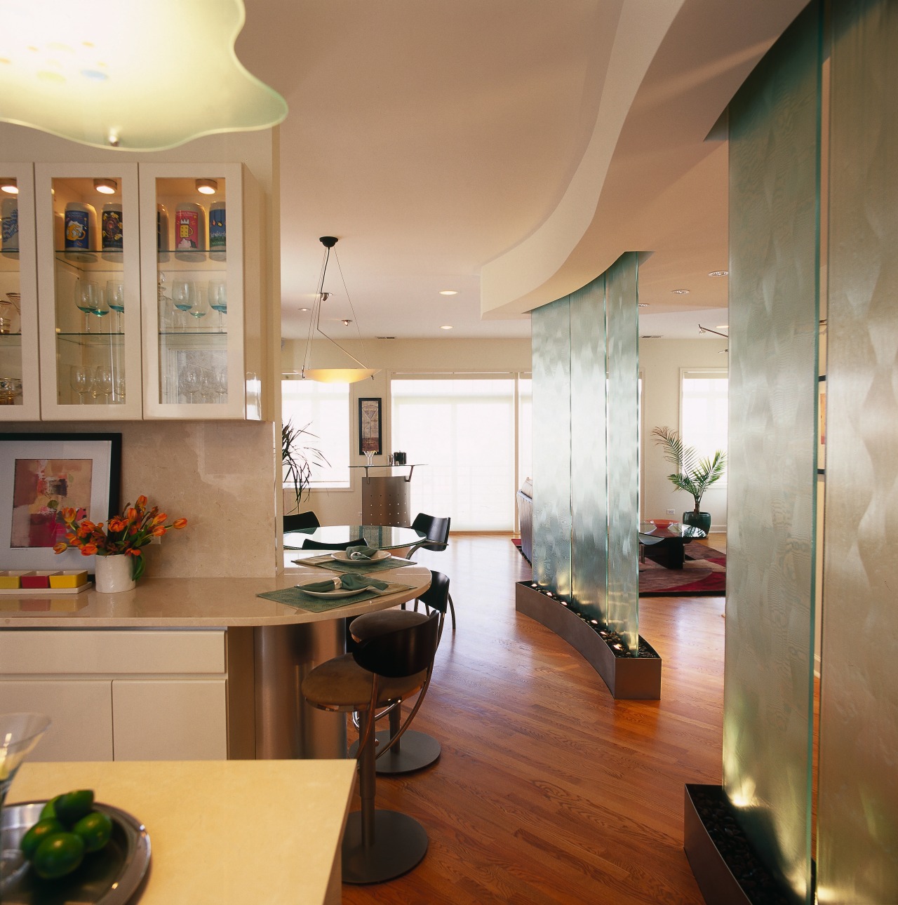 Glass in the partitions is echoed in the ceiling, countertop, floor, flooring, interior design, kitchen, living room, real estate, room, brown