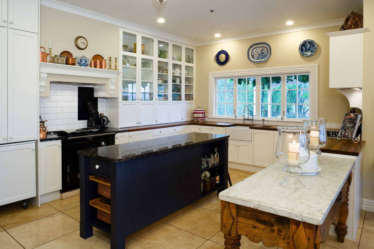 A view of this kitchen featuring tiled flooring, countertop, cuisine classique, interior design, kitchen, property, real estate, room, gray