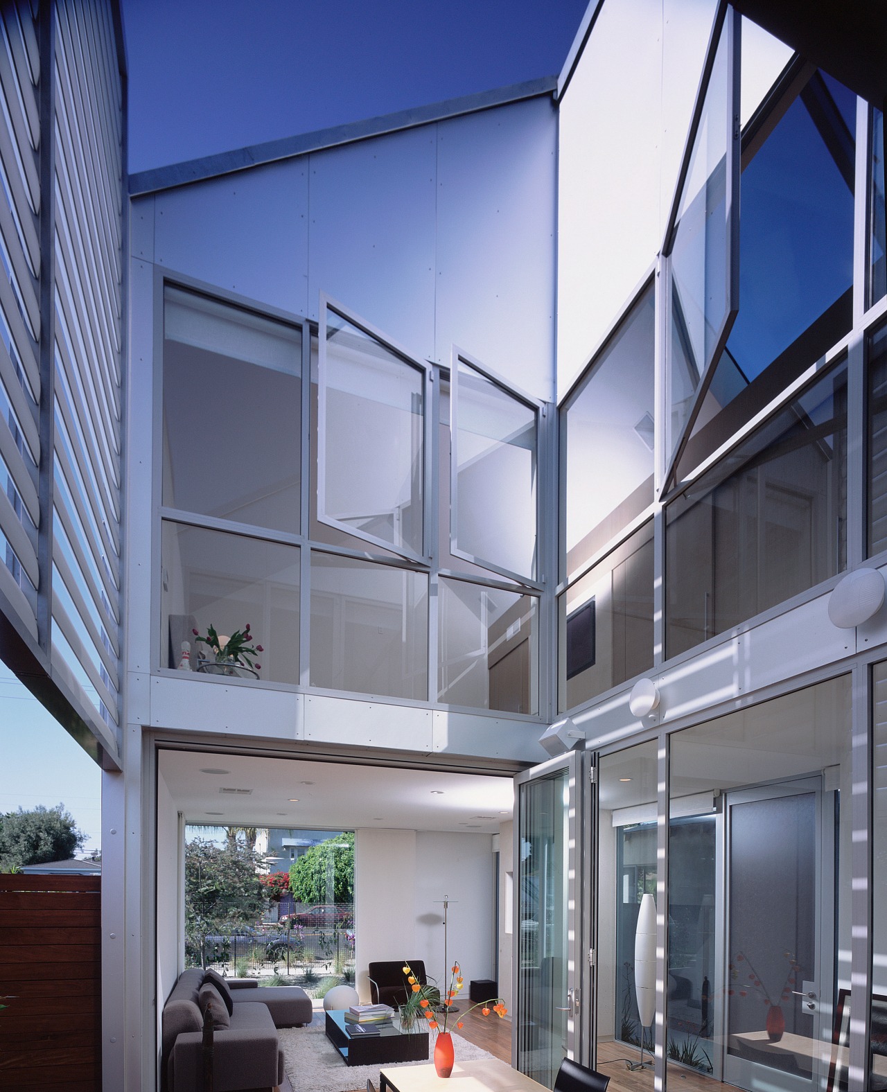 An interior view of the living area featuring architecture, building, ceiling, corporate headquarters, daylighting, facade, home, house, interior design, mixed use, real estate, window, gray, blue