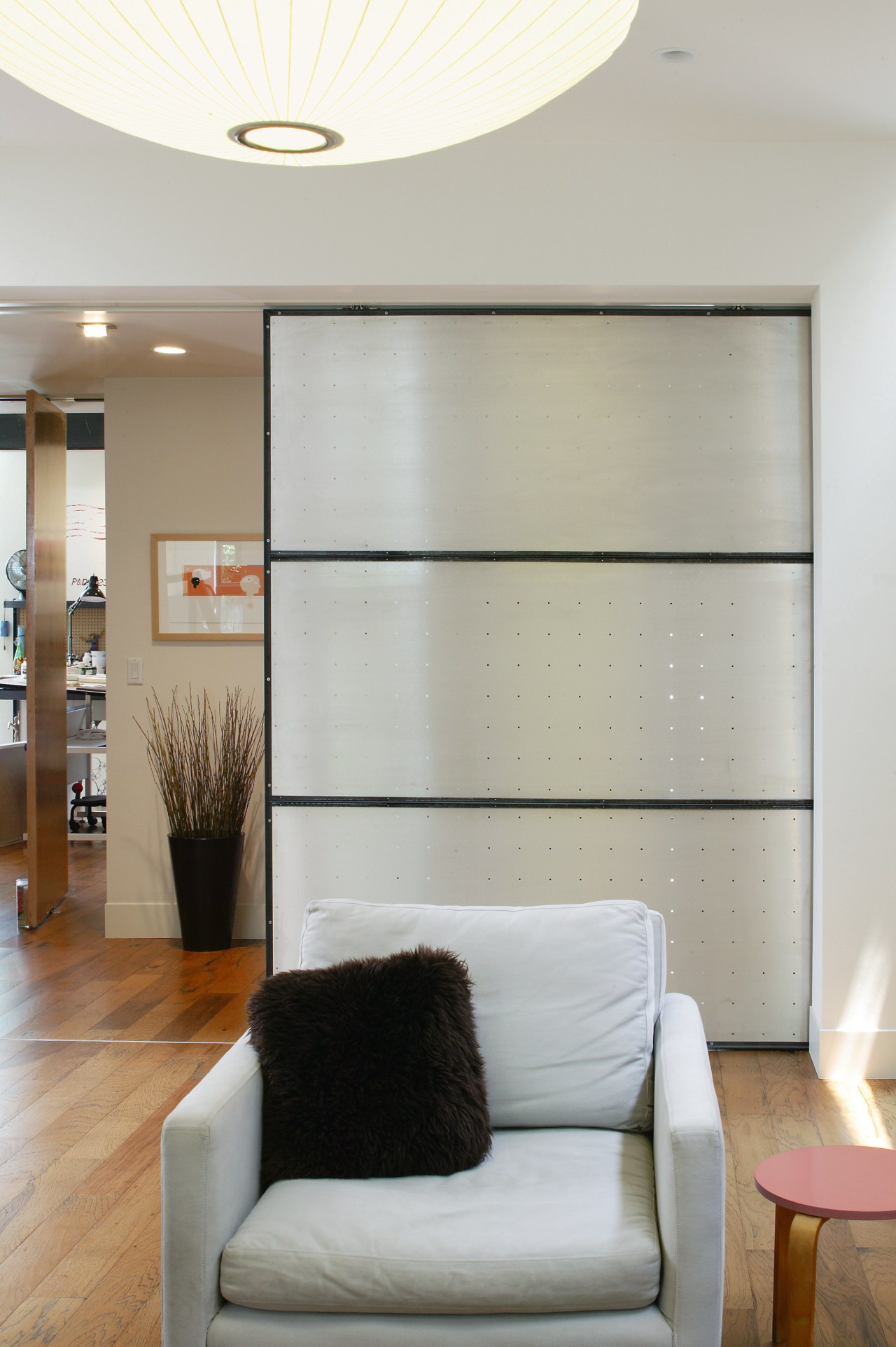 An interior view of the living area featuring ceiling, floor, furniture, interior design, living room, room, wall, window, gray