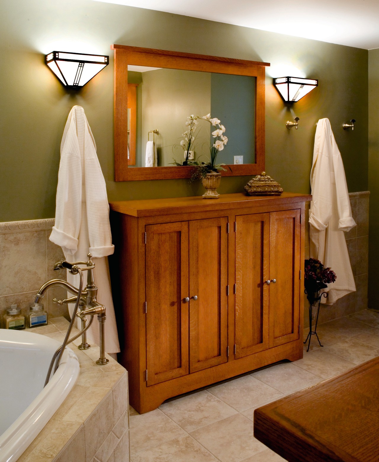 A view of this bathroom features a steam bathroom, cabinetry, chest of drawers, floor, flooring, furniture, home, interior design, room, brown