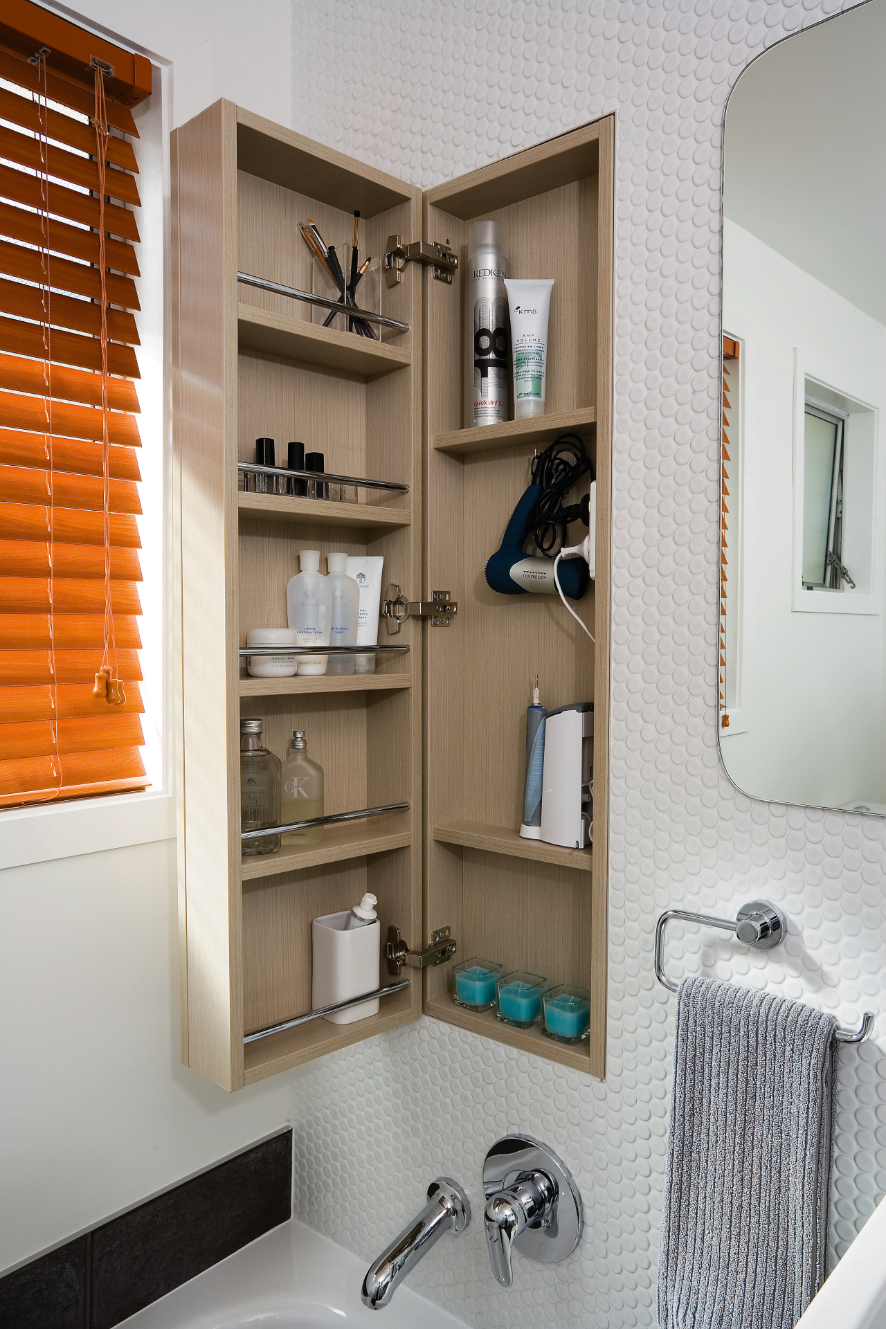 A view of a bathroom designed by Yellowfox. bathroom, bathroom accessory, bathroom cabinet, bookcase, cabinetry, furniture, interior design, product design, room, shelf, shelving, gray, brown