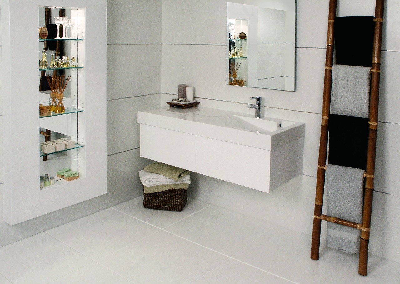 View of this bathroom featuring white cabinetry, stainless bathroom, bathroom accessory, bathroom cabinet, floor, flooring, furniture, interior design, product design, shelf, shelving, sink, tap, tile, gray