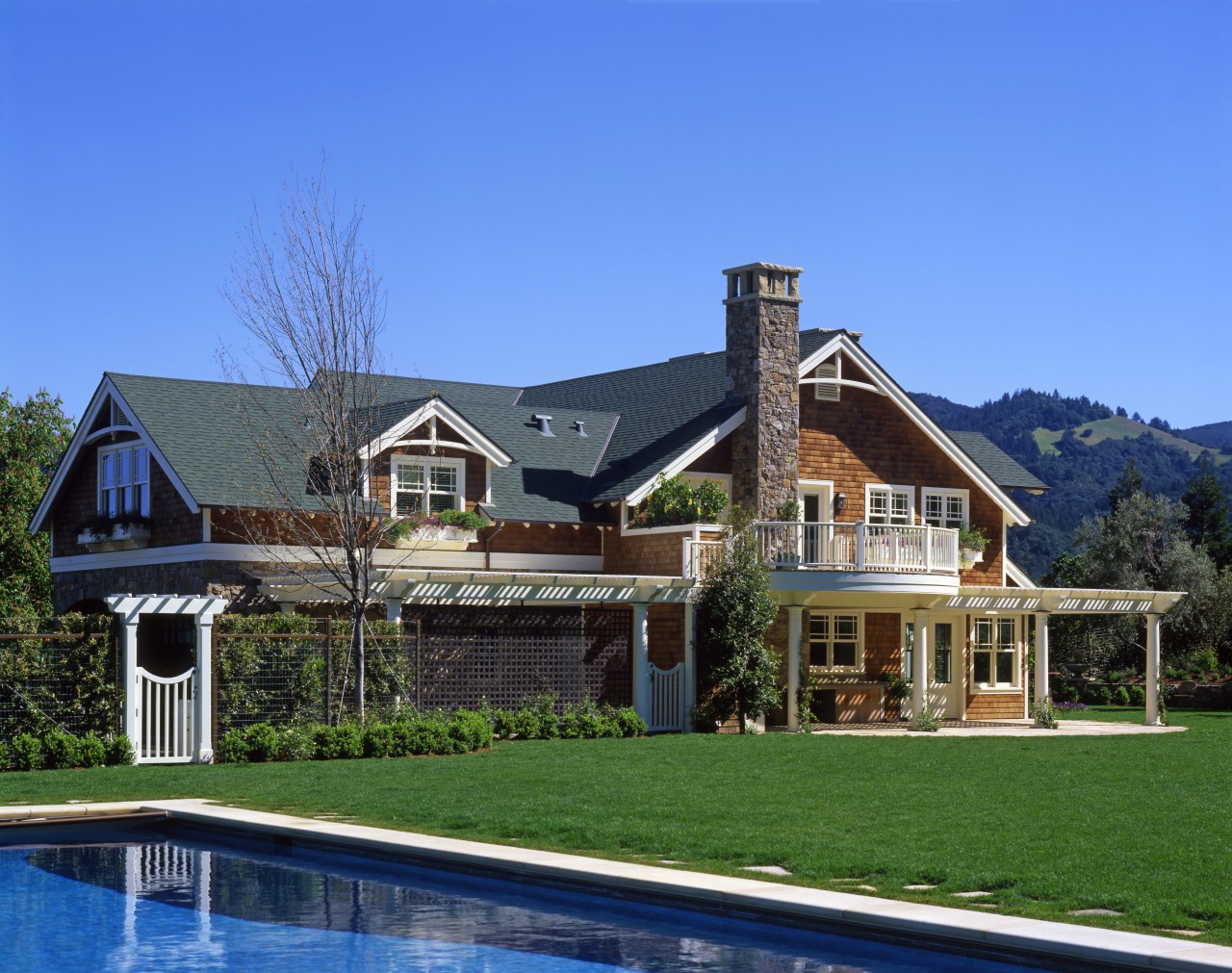 An exterior view of this traditional masonry home cottage, elevation, estate, facade, farmhouse, home, house, mansion, property, real estate, residential area, roof, siding, villa, blue