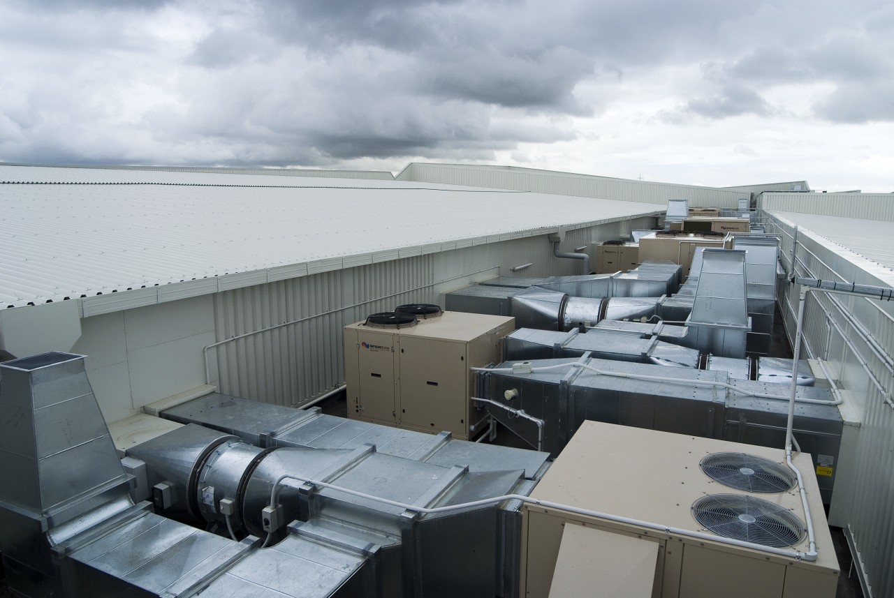 A view of an air conditioning unit from architecture, roof, water, gray