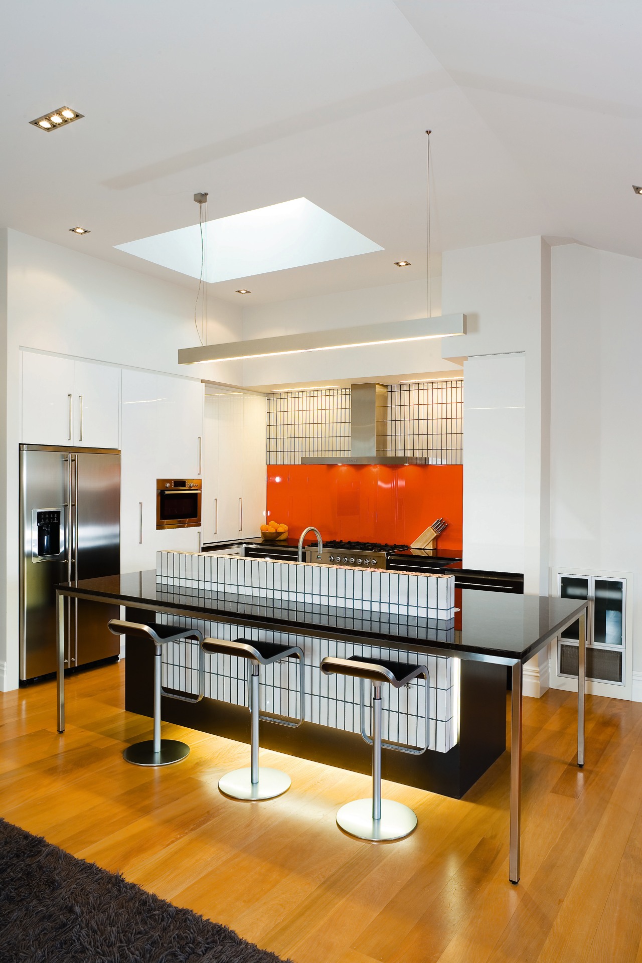 A view of this kitchen featuring kauri flooring, ceiling, furniture, interior design, kitchen, room, table, gray, white