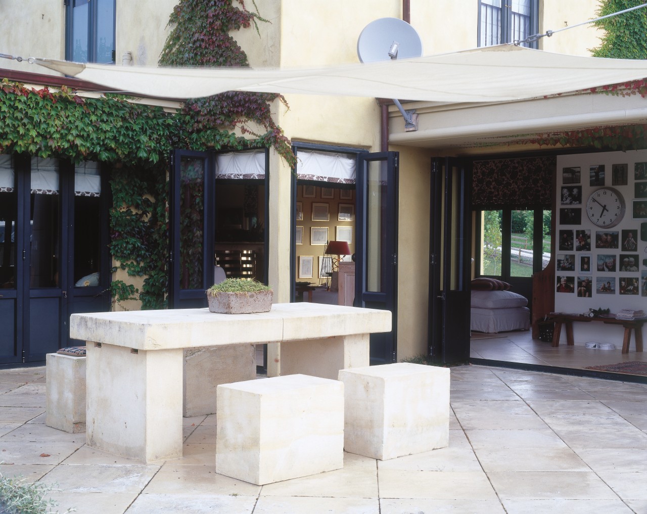 A view of the large outdoor courtyard  courtyard, furniture, outdoor structure, patio, table, white