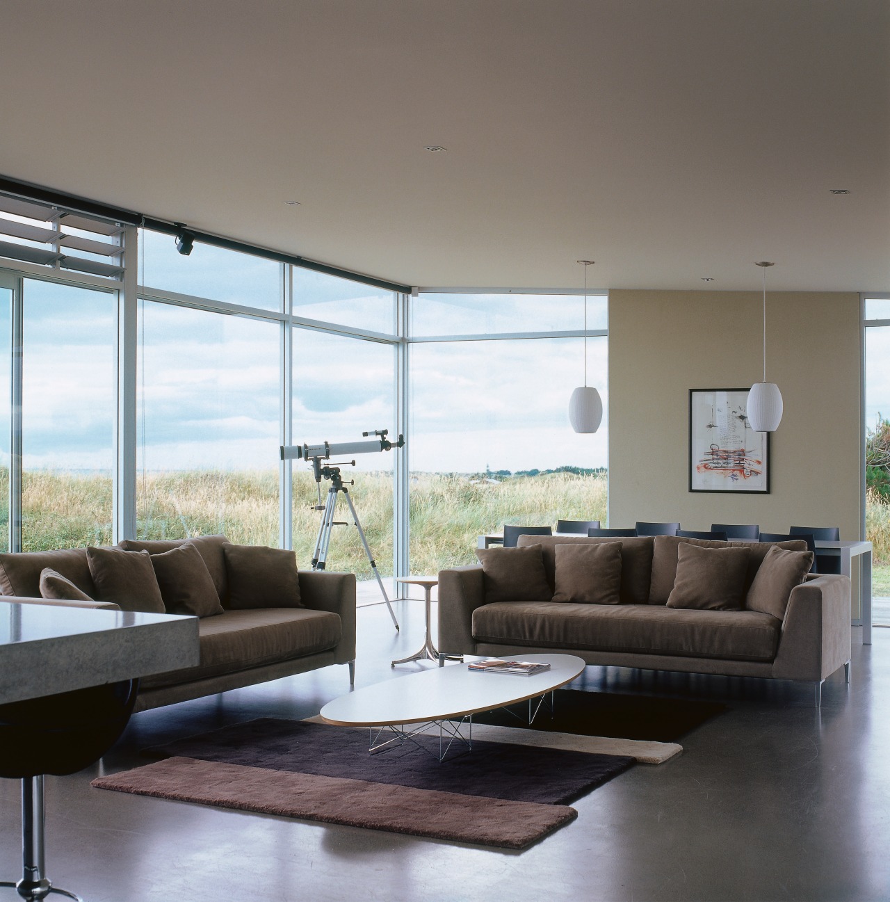 An interior view of the living area featuring ceiling, couch, daylighting, furniture, house, interior design, living room, table, window, gray