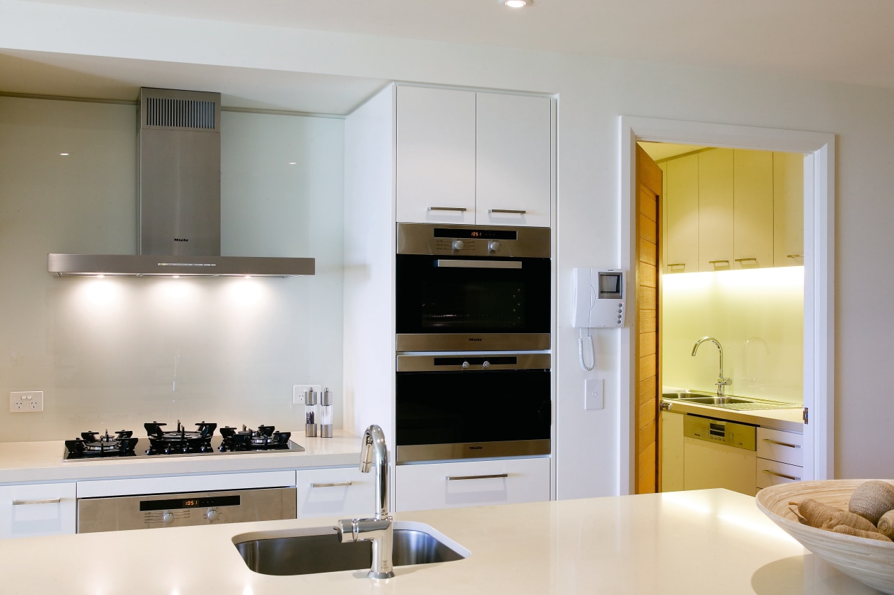 A view of this kitchen apartment featuring white cabinetry, countertop, cuisine classique, interior design, kitchen, room, gray