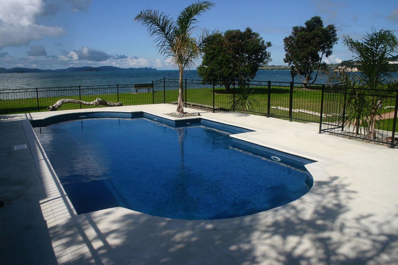 A view of a swimming pool by Cascade. estate, leisure, property, real estate, reflection, resort, sky, swimming pool, tree, vacation, water, blue