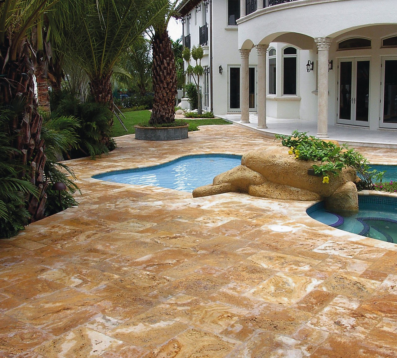 A view of Marble and travetine pavers with backyard, driveway, estate, flagstone, floor, flooring, home, landscape, landscaping, outdoor structure, patio, real estate, walkway, brown, orange