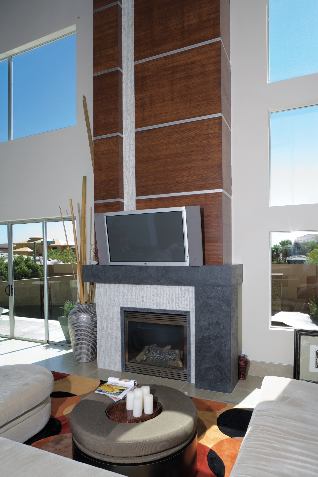 The fireplace surround features pre-cast GFRC cast stone fireplace, hearth, interior design, living room, gray