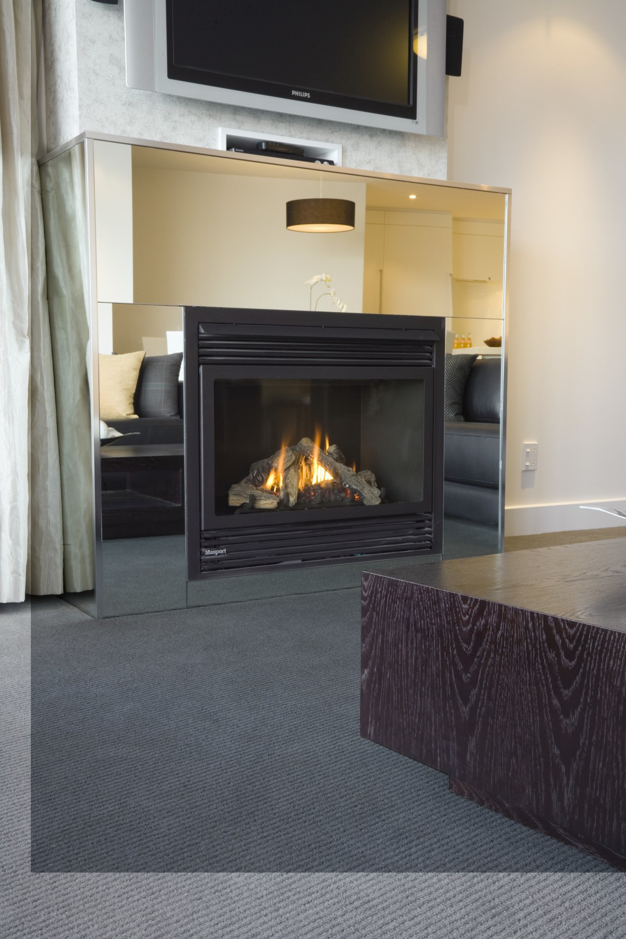 A view of the custom designed grey feltex fireplace, floor, flooring, hearth, heat, home appliance, wood burning stove, wood flooring, gray, black