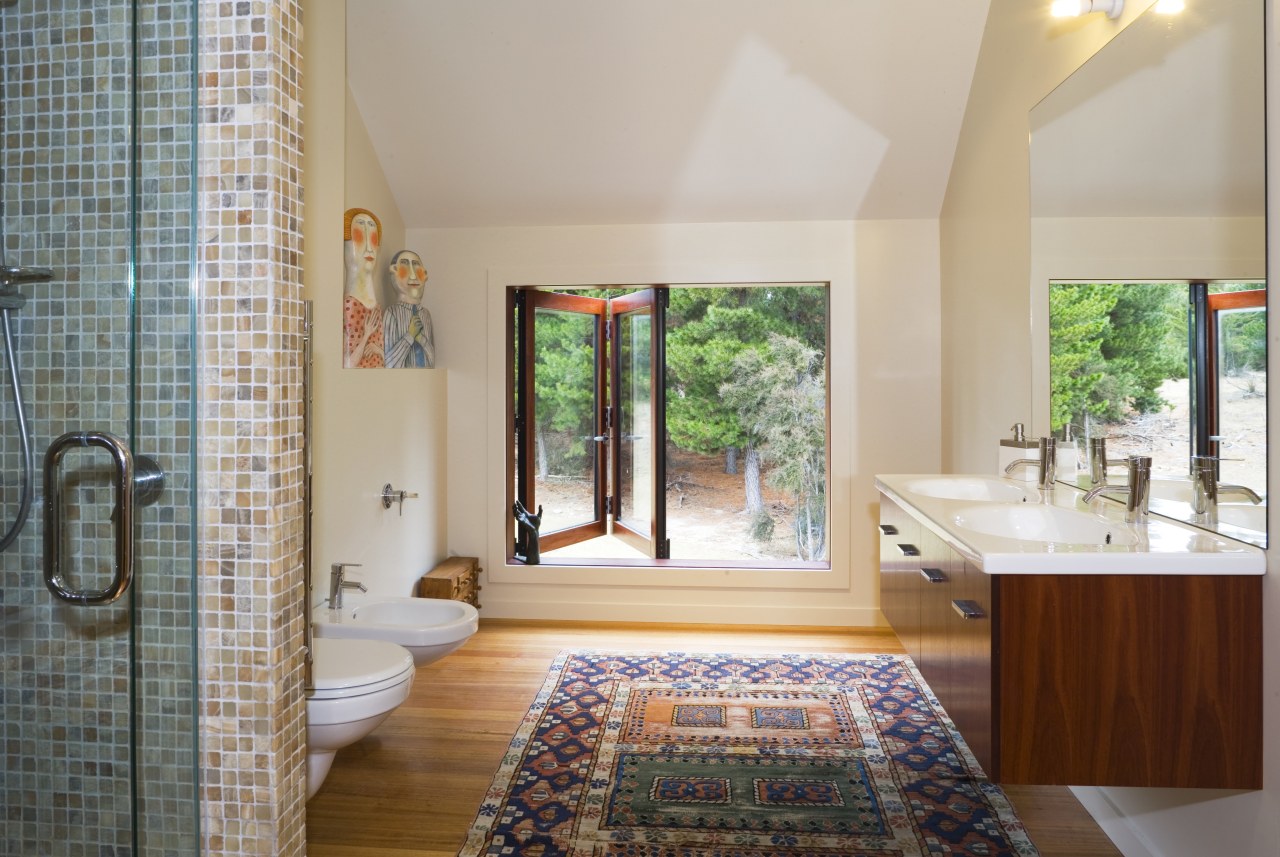 A view of the downstairs bathroom featuring toilet, architecture, bathroom, estate, floor, home, interior design, real estate, room, window, gray