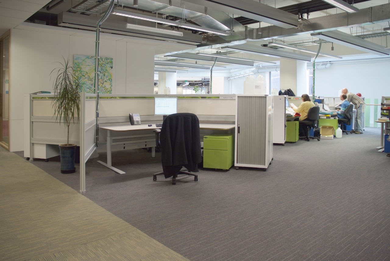 A view of this commercial office aspace featuring floor, flooring, office, gray