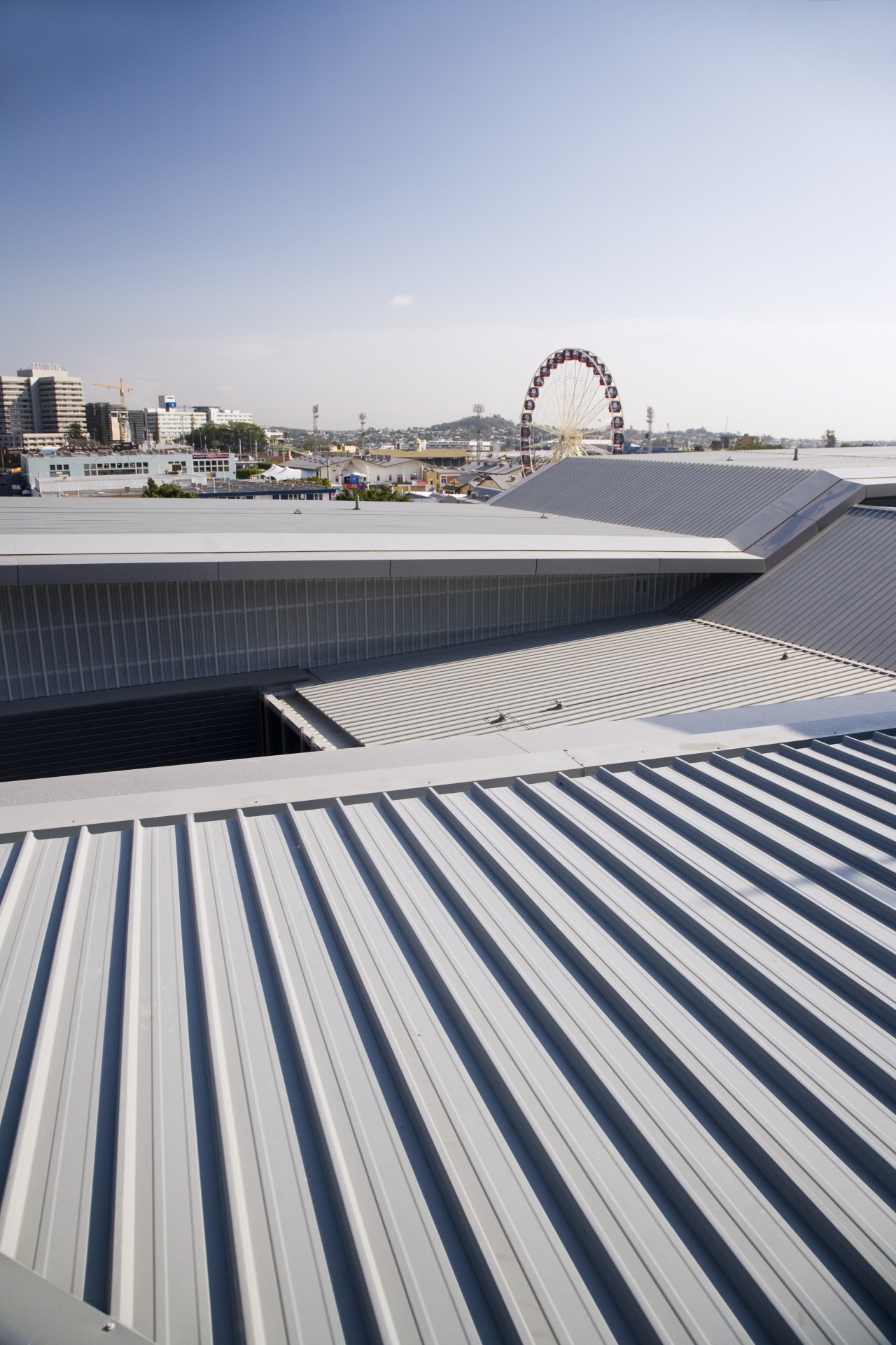 A view of the metal roofing and fibreglass architecture, building, daylighting, daytime, fixed link, line, outdoor structure, roof, sky, structure, water, white, gray