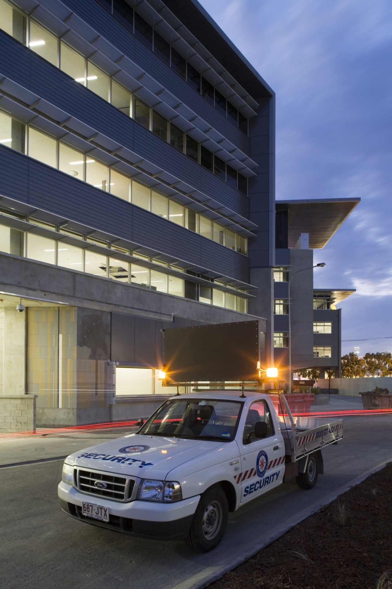 An exterior view of the Greensquare building where automotive design, building, car, compact car, daytime, family car, luxury vehicle, metropolitan area, motor vehicle, sedan, sky, sport utility vehicle, transport, vehicle, black