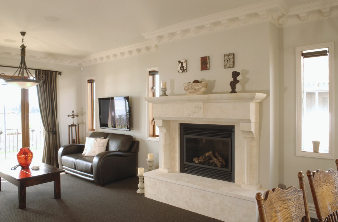 A view of a fireplace from The Natural ceiling, estate, fireplace, floor, hearth, home, interior design, living room, property, real estate, room, wall, wood burning stove, orange