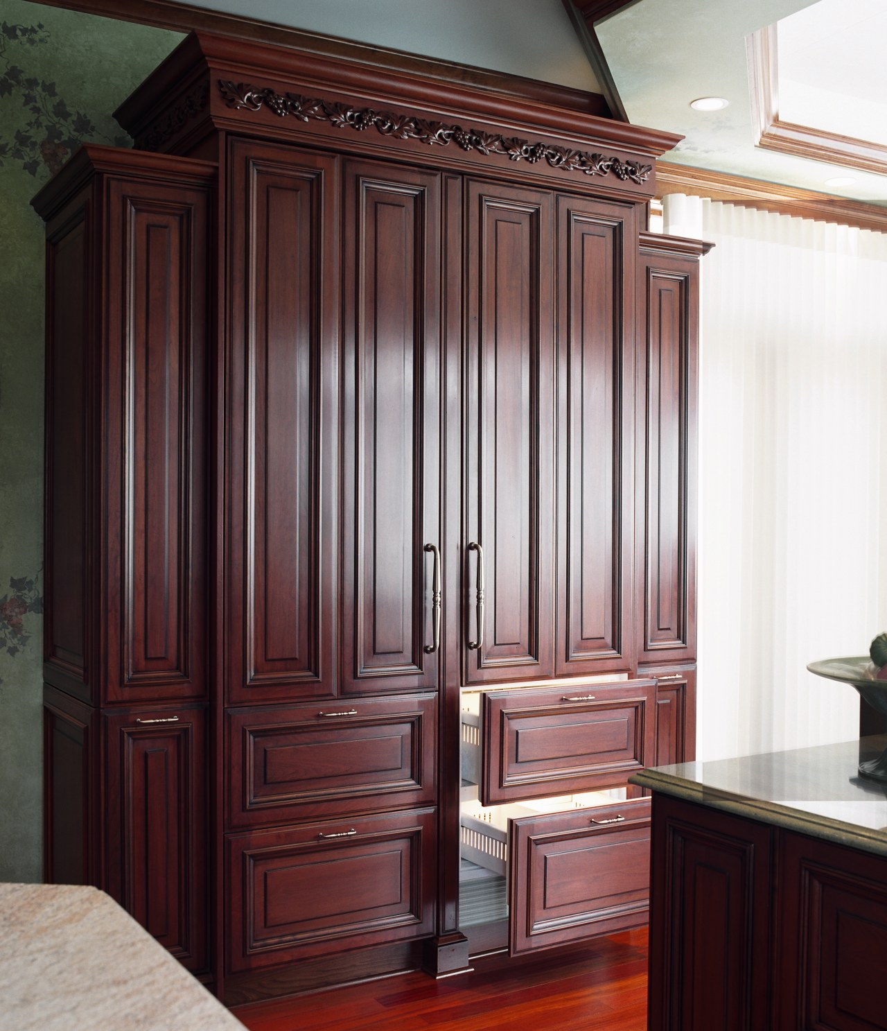 A view of a kitchen designed by Better cabinetry, chest of drawers, closet, cupboard, door, furniture, wardrobe, wood stain, red, white