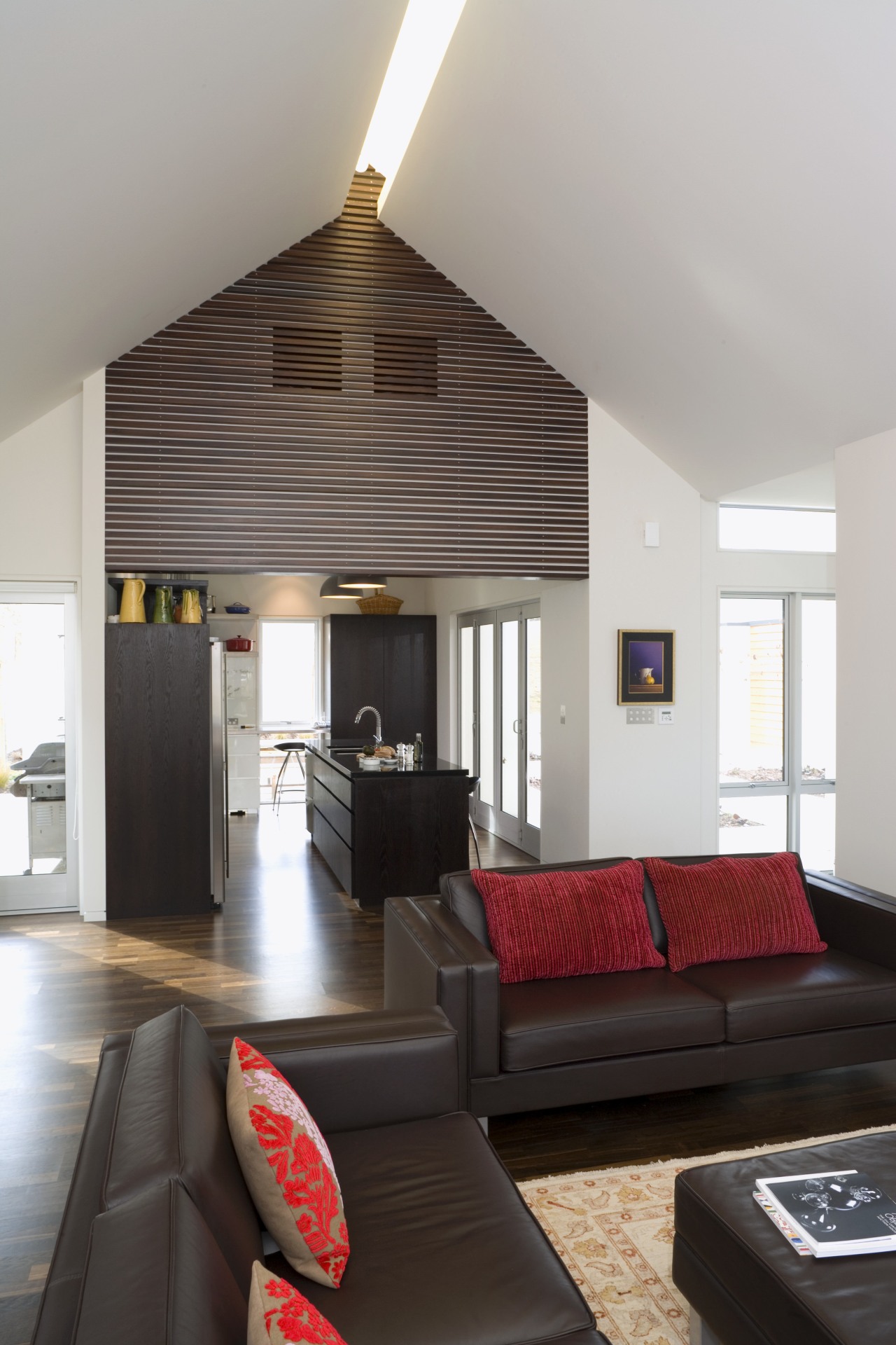 View of kitchen and living area designed by architecture, ceiling, daylighting, floor, house, interior design, living room, loft, real estate, room, gray, black