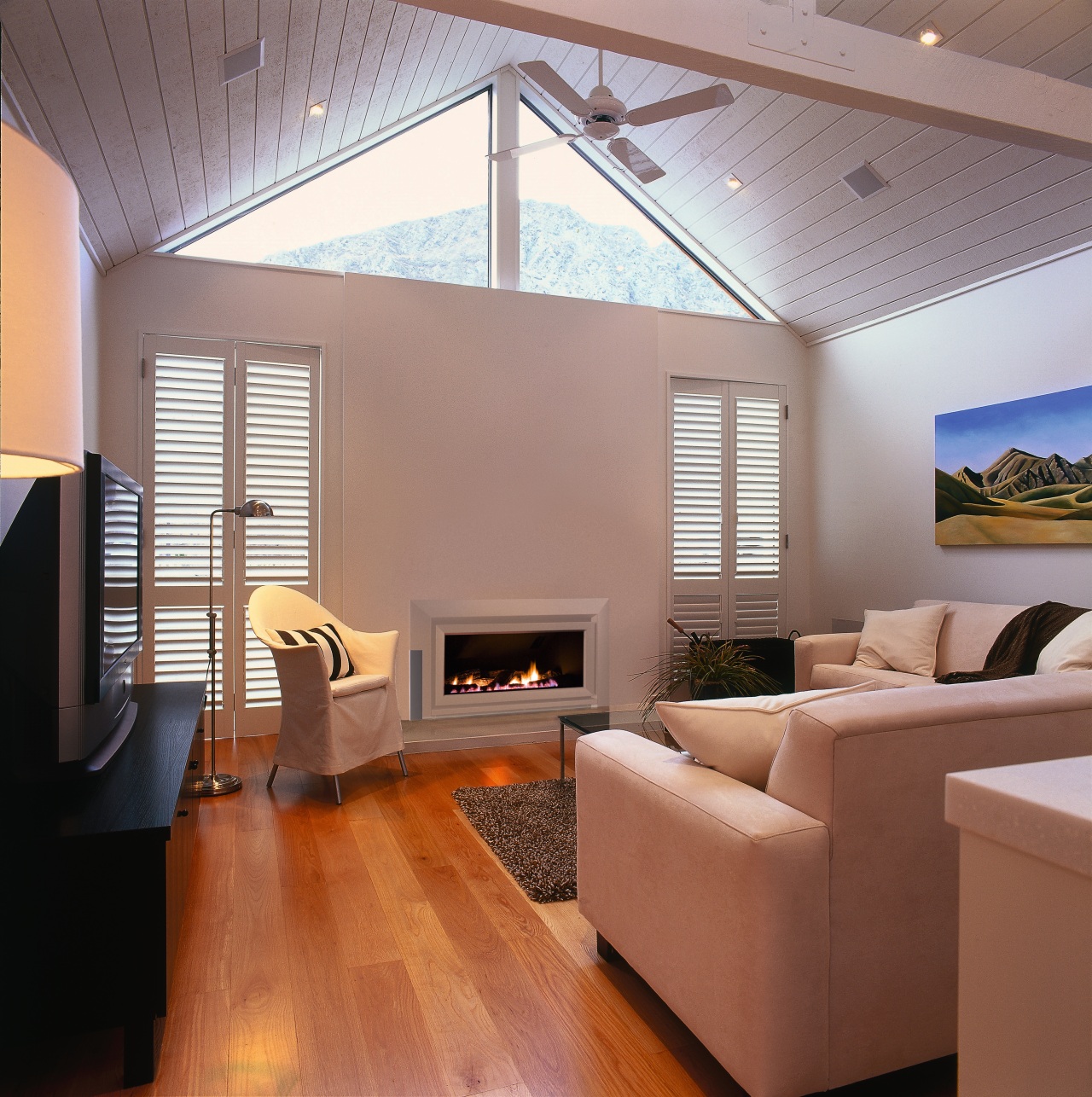 A view of this living area featuring this architecture, ceiling, daylighting, floor, flooring, hardwood, house, interior design, laminate flooring, living room, real estate, room, wall, window, wood, wood flooring, gray, red