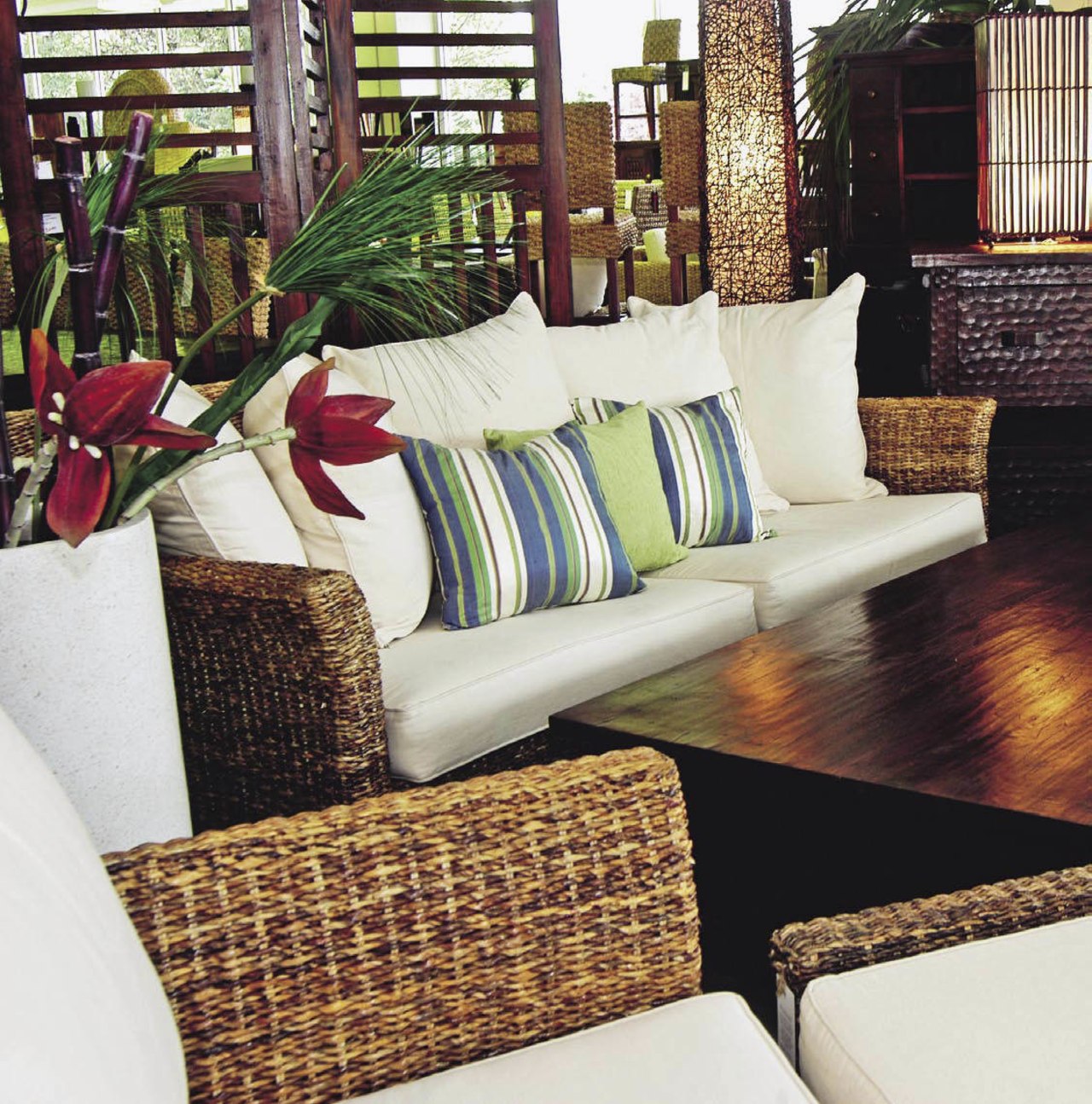 A view of this Samarang furniture that features chair, couch, cushion, flooring, furniture, home, interior design, living room, table, wicker, wood, white