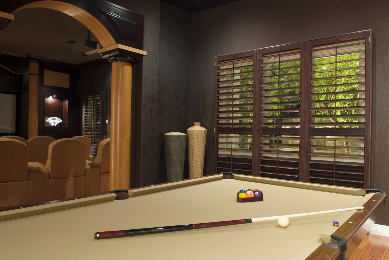 A view of the interior living areas featuring billiard room, billiard table, english billiards, games, indoor games and sports, interior design, pool, recreation room, room, table, wood, brown, black