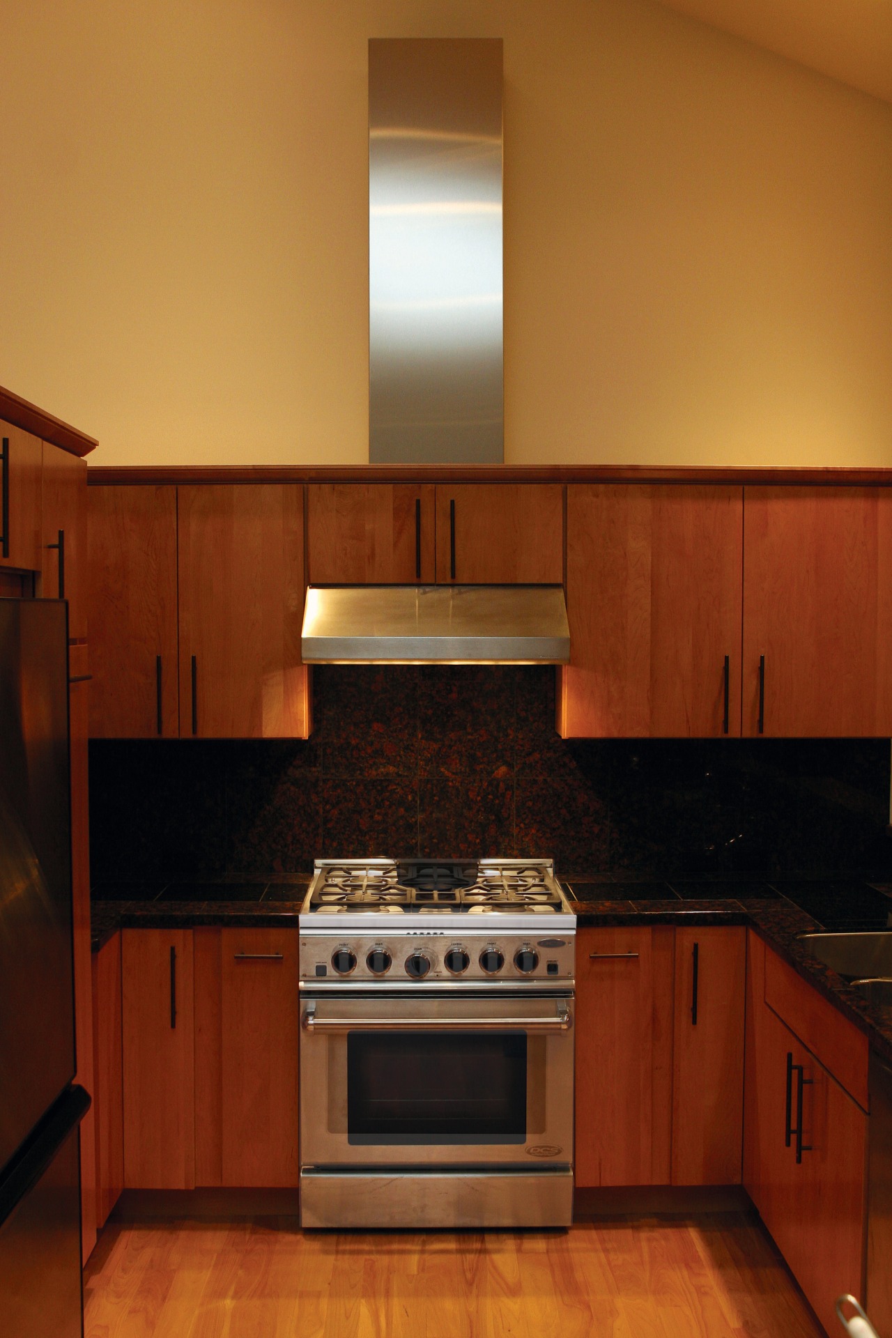 A view of some kitchen appliances from Fisher cabinetry, countertop, cuisine classique, floor, flooring, hardwood, home, home appliance, interior design, kitchen, kitchen stove, room, under cabinet lighting, wood, red