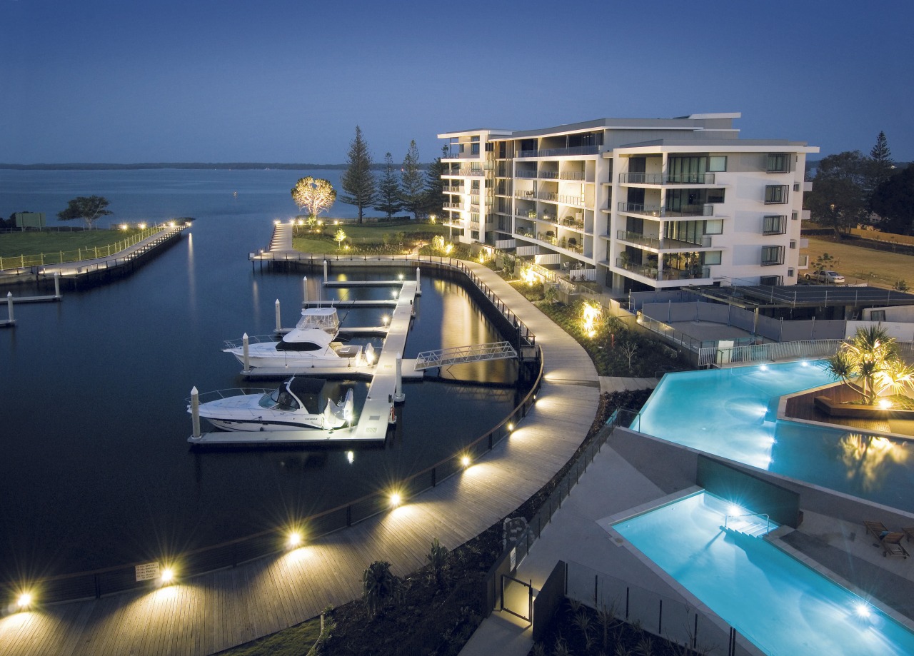 An exterior view of the New Stocland Allisse condominium, dock, hotel, luxury yacht, marina, mixed use, passenger ship, property, real estate, resort, yacht, blue