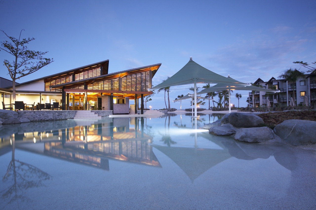 The main pool and beach resturant at Radisson architecture, estate, evening, home, hotel, leisure, mixed use, real estate, reflection, resort, resort town, sky, swimming pool, water, teal, blue