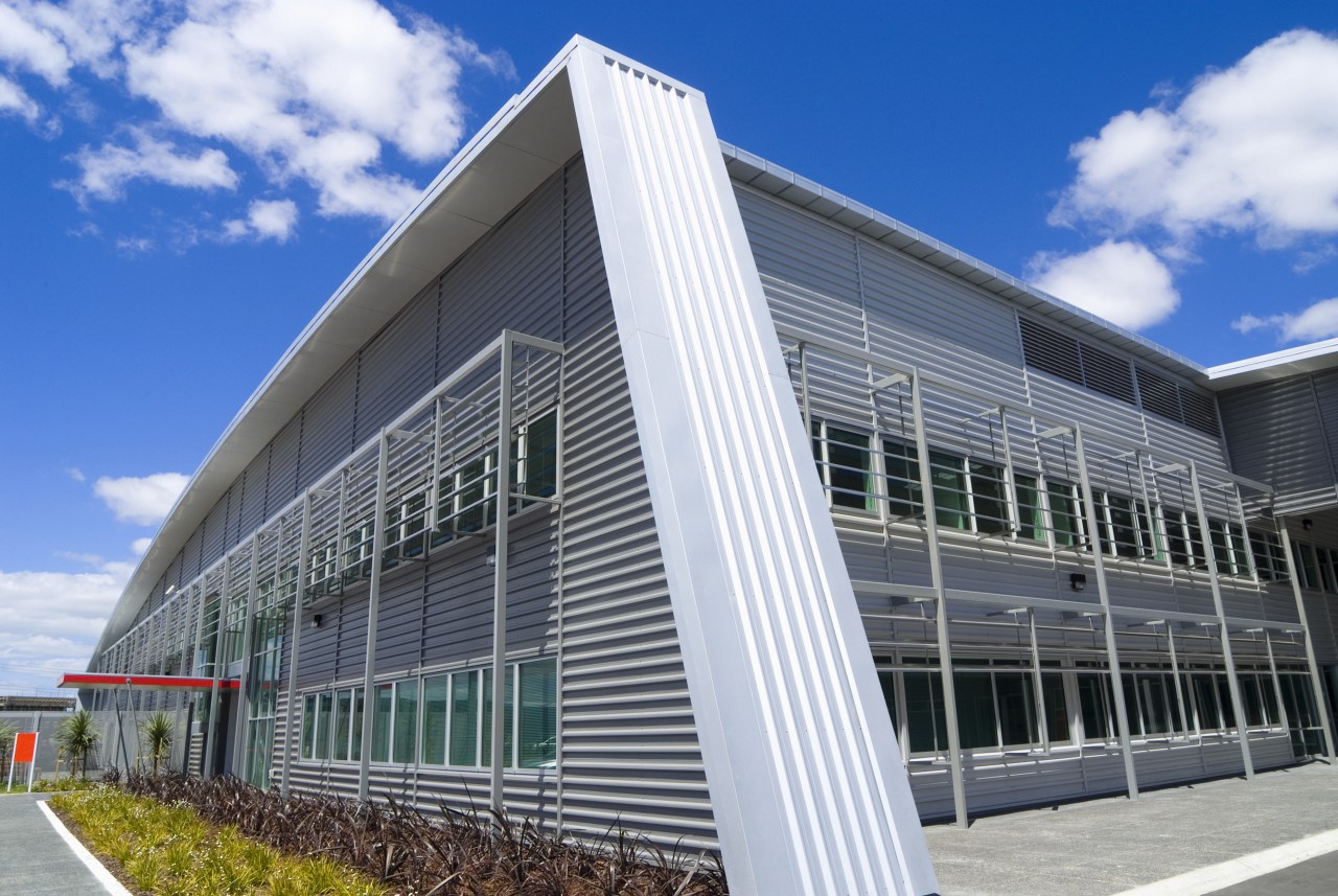 Stuated on landscape grounds, Highbrook business park consists architecture, building, commercial building, corporate headquarters, daytime, facade, headquarters, mixed use, real estate, sky, structure, gray