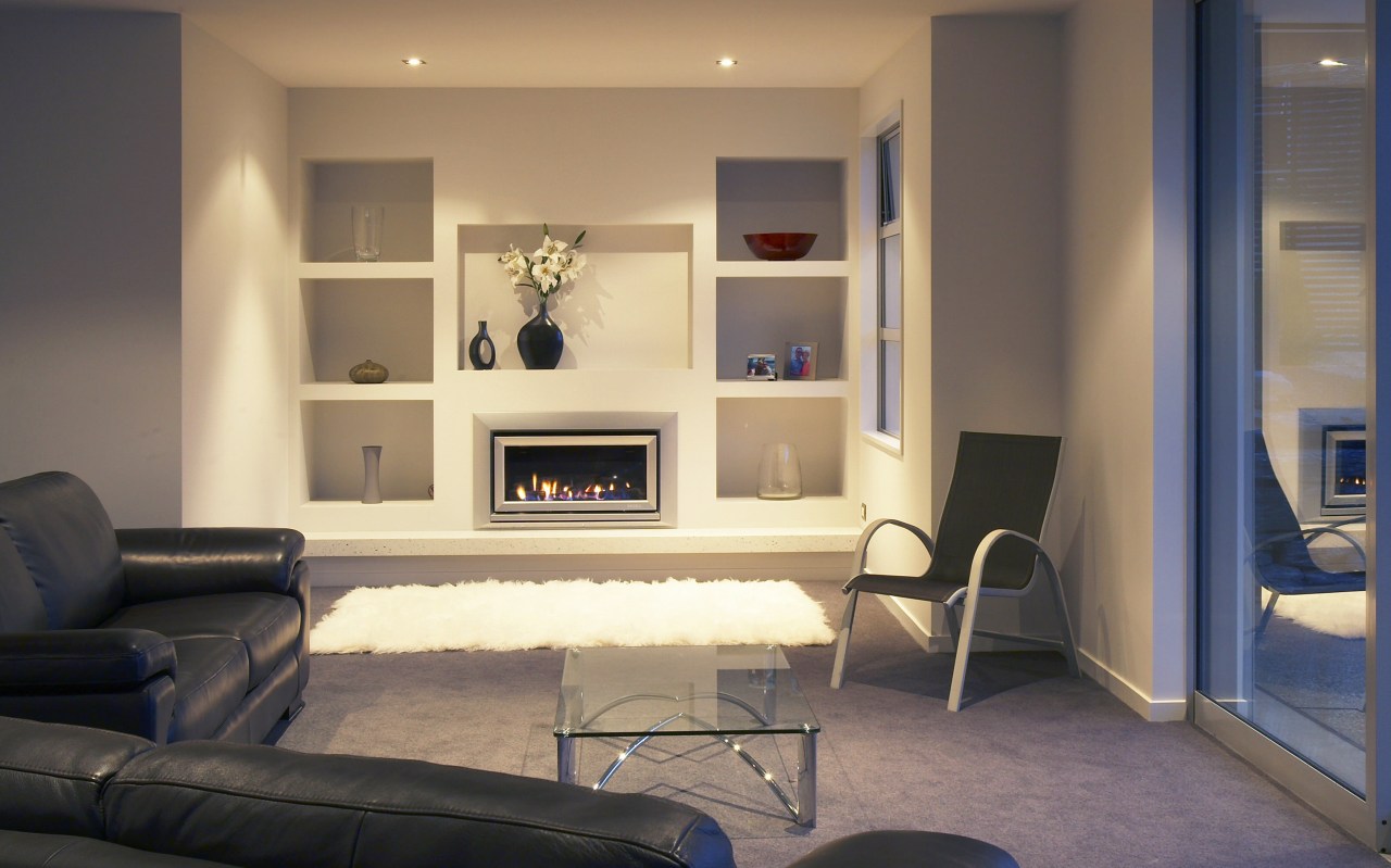 A view of a fireplace from Escea. floor, flooring, furniture, home, interior design, living room, room, shelving, wall, orange