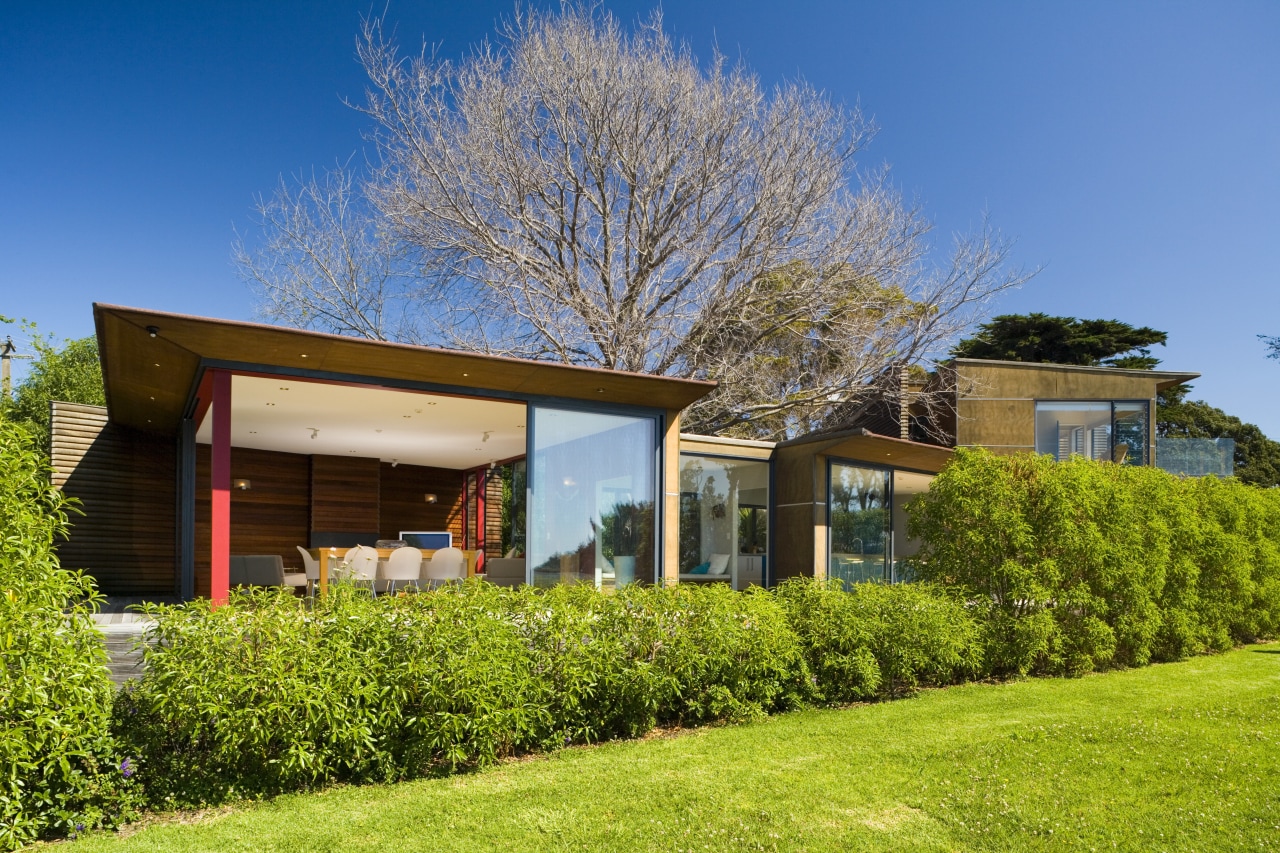 An exterior view of the home, windows and architecture, cottage, estate, facade, farmhouse, grass, home, house, landscape, lawn, plant, property, real estate, residential area, roof, siding, sky, suburb, tree, villa, yard