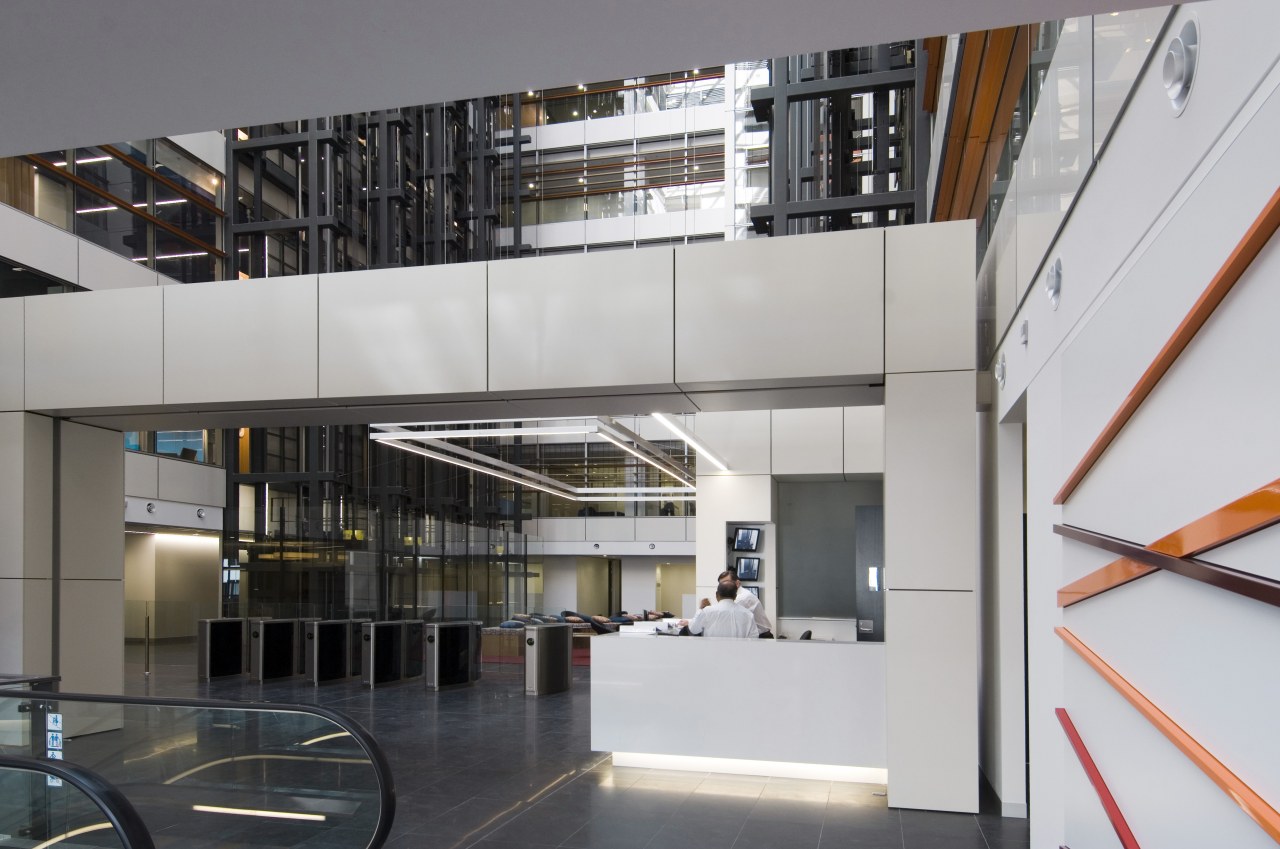 interior view of building featuring escalators, lighting, doors architecture, building, glass, institution, interior design, lobby, stairs, gray