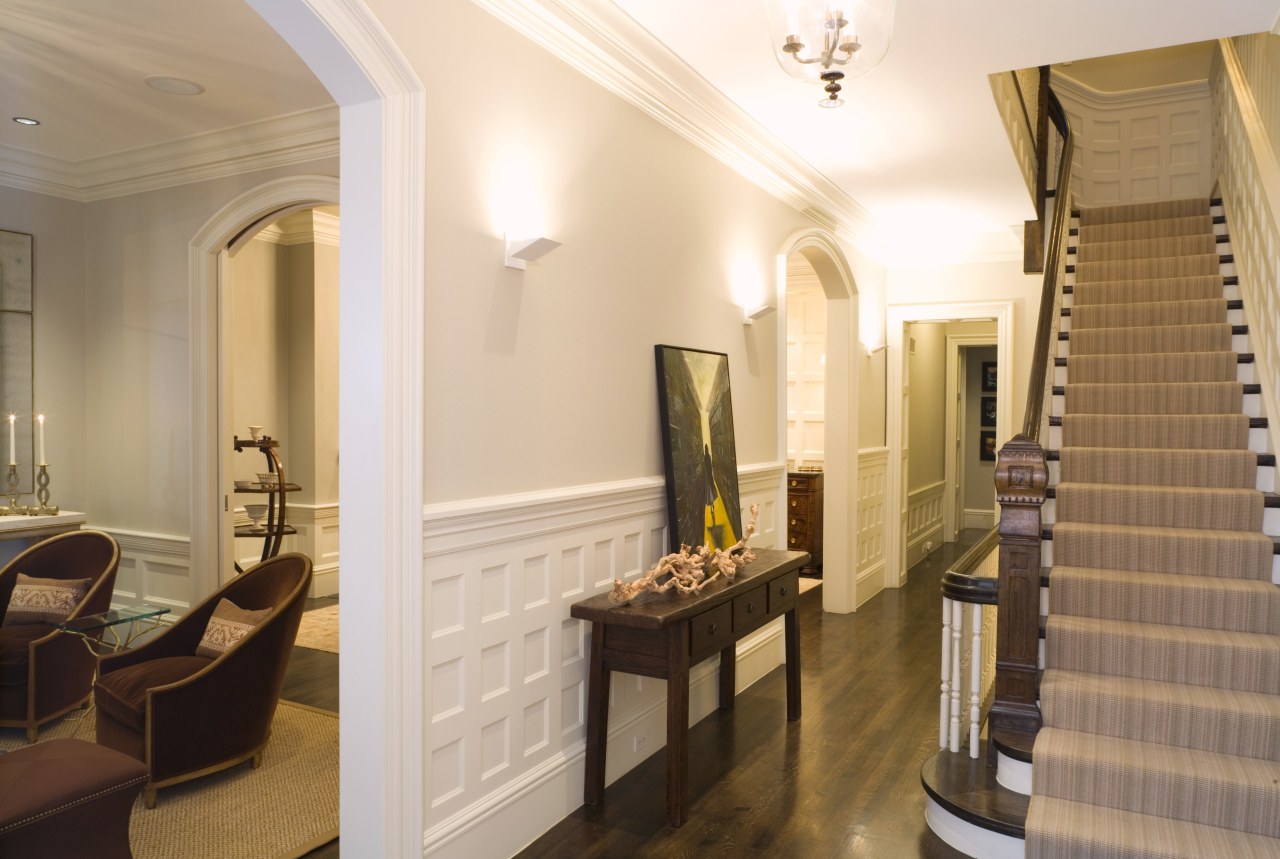 view of stairway featuring white walls, carpeted stairs, ceiling, estate, flooring, interior design, lobby, property, real estate, room, suite, brown, white, orange