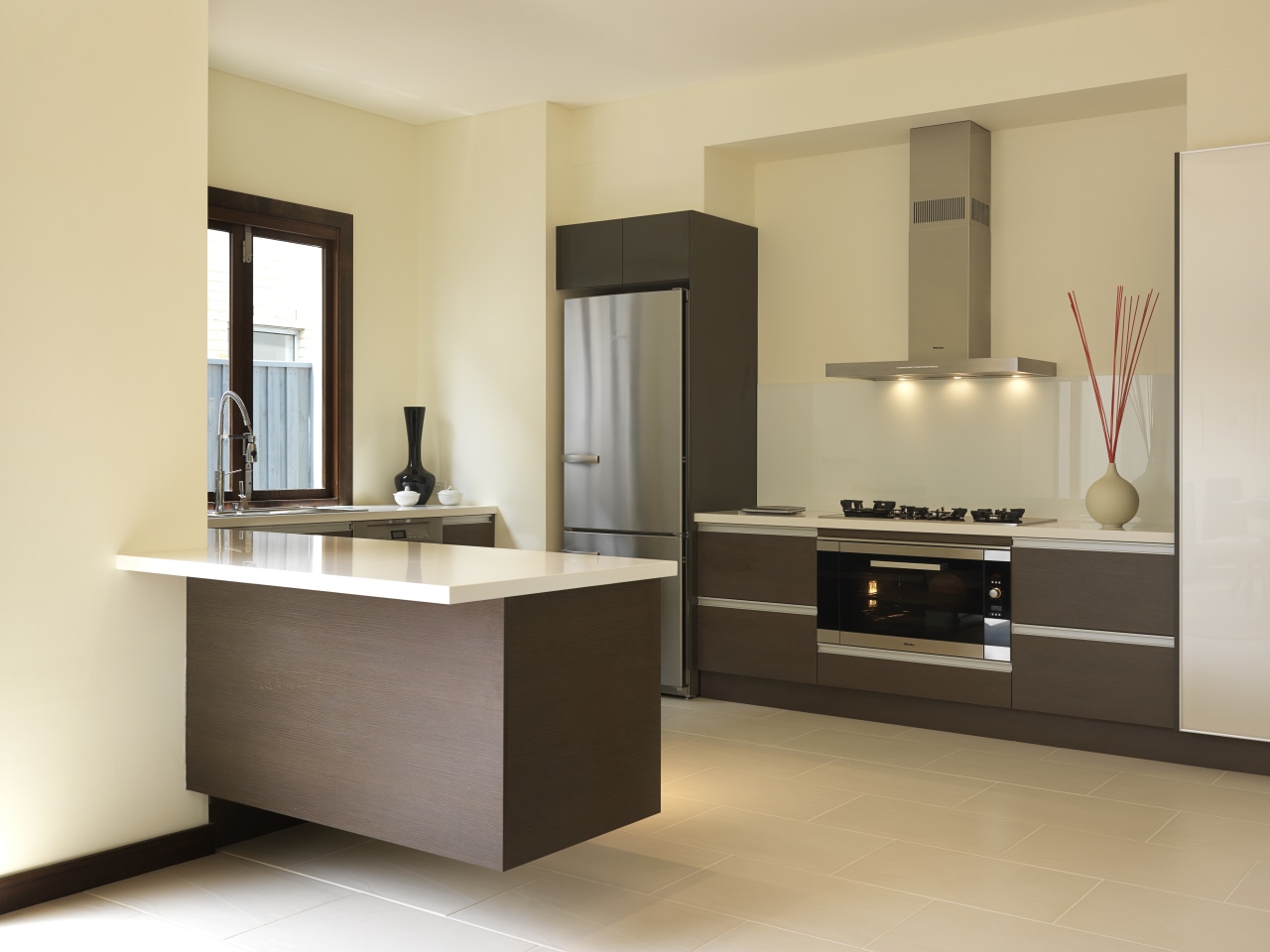 Rather than specifying standard 60cm cooking appliances, the cabinetry, countertop, floor, furniture, interior design, kitchen, product design, room, sink, orange, brown