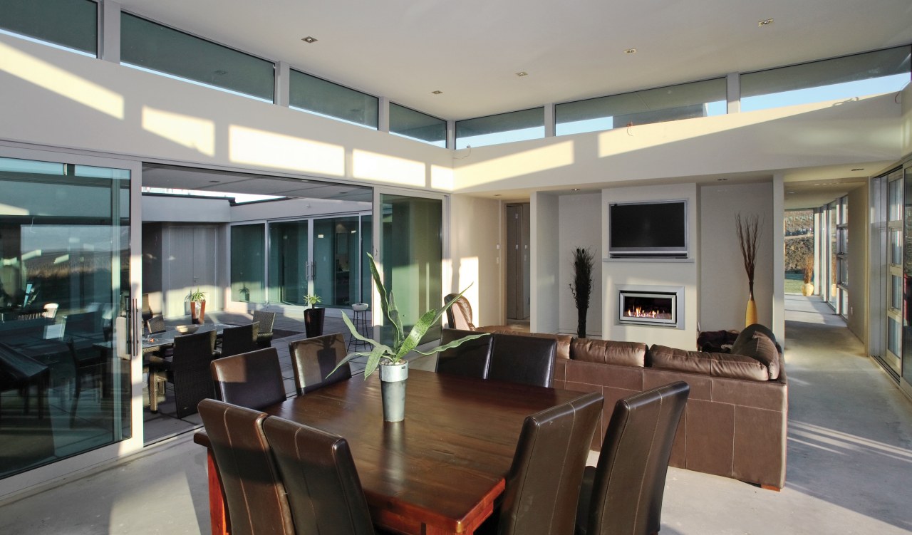 A view of a fireplace by Escea. ceiling, house, interior design, living room, penthouse apartment, property, real estate, window, gray