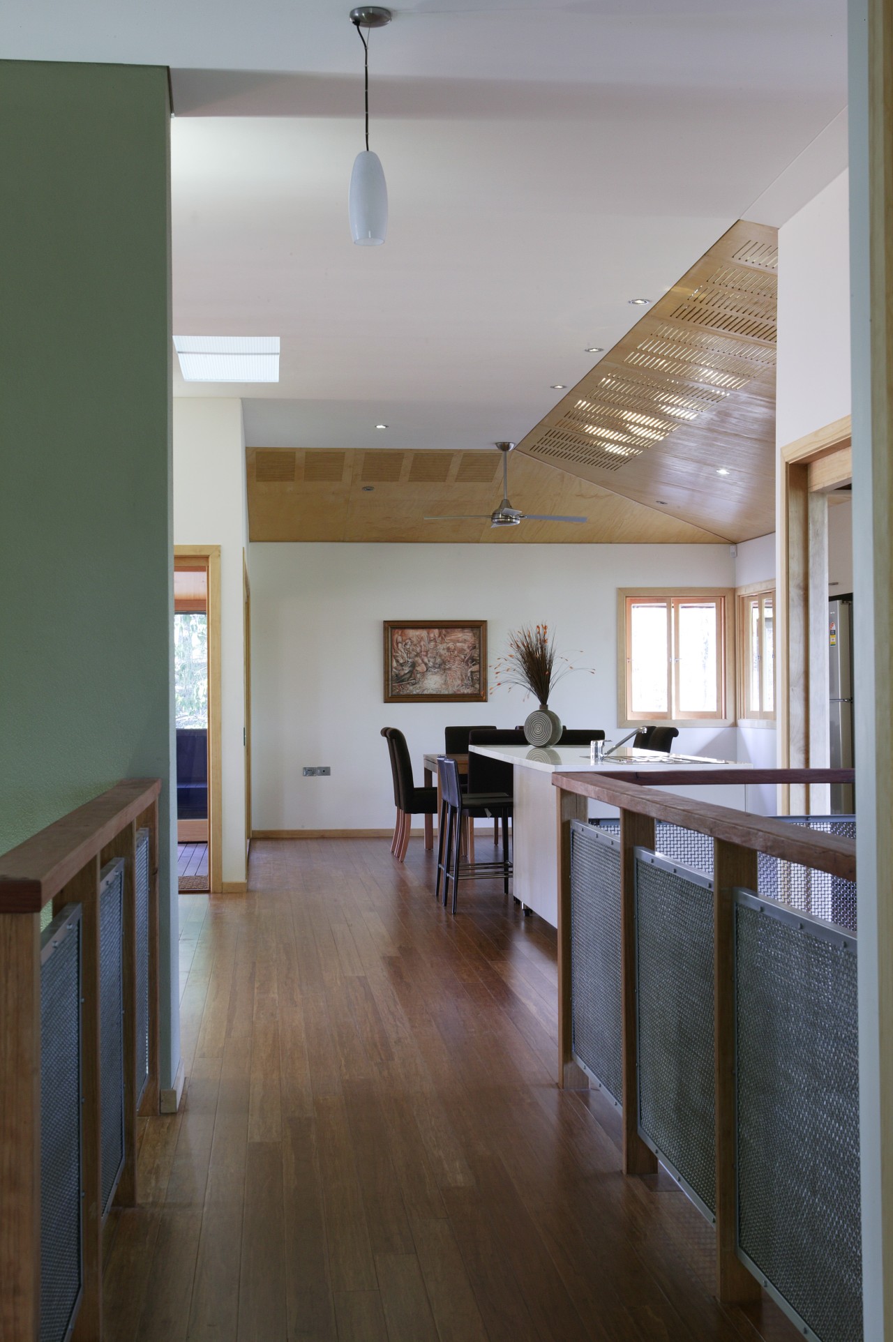 Hallway leading to dining area inside sustainable home architecture, ceiling, daylighting, floor, flooring, hardwood, home, house, interior design, kitchen, laminate flooring, living room, real estate, room, wood, wood flooring, gray