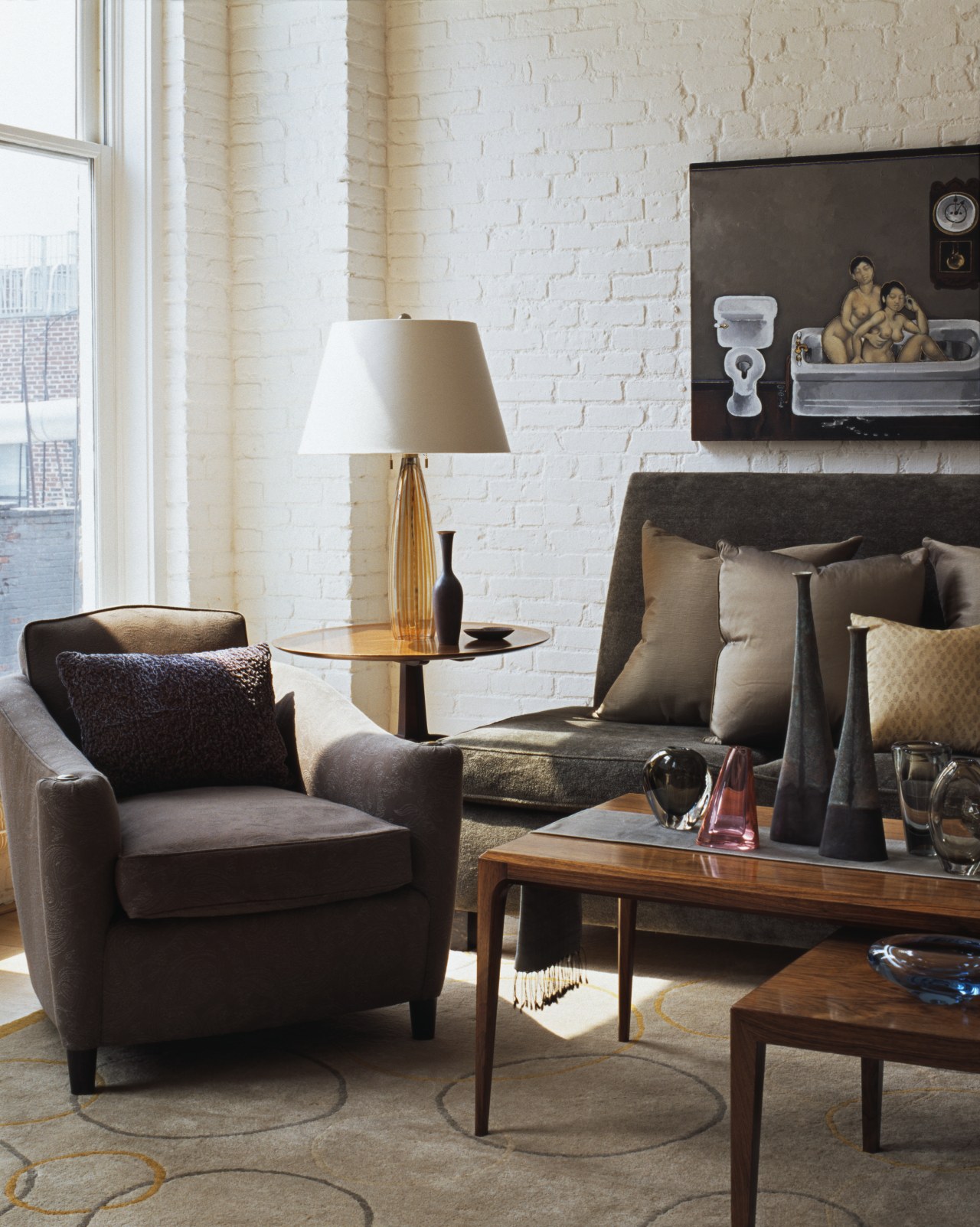 View of a living area in this apartment chair, coffee table, couch, furniture, home, interior design, lamp, lighting accessory, living room, loveseat, product design, room, table, black, gray