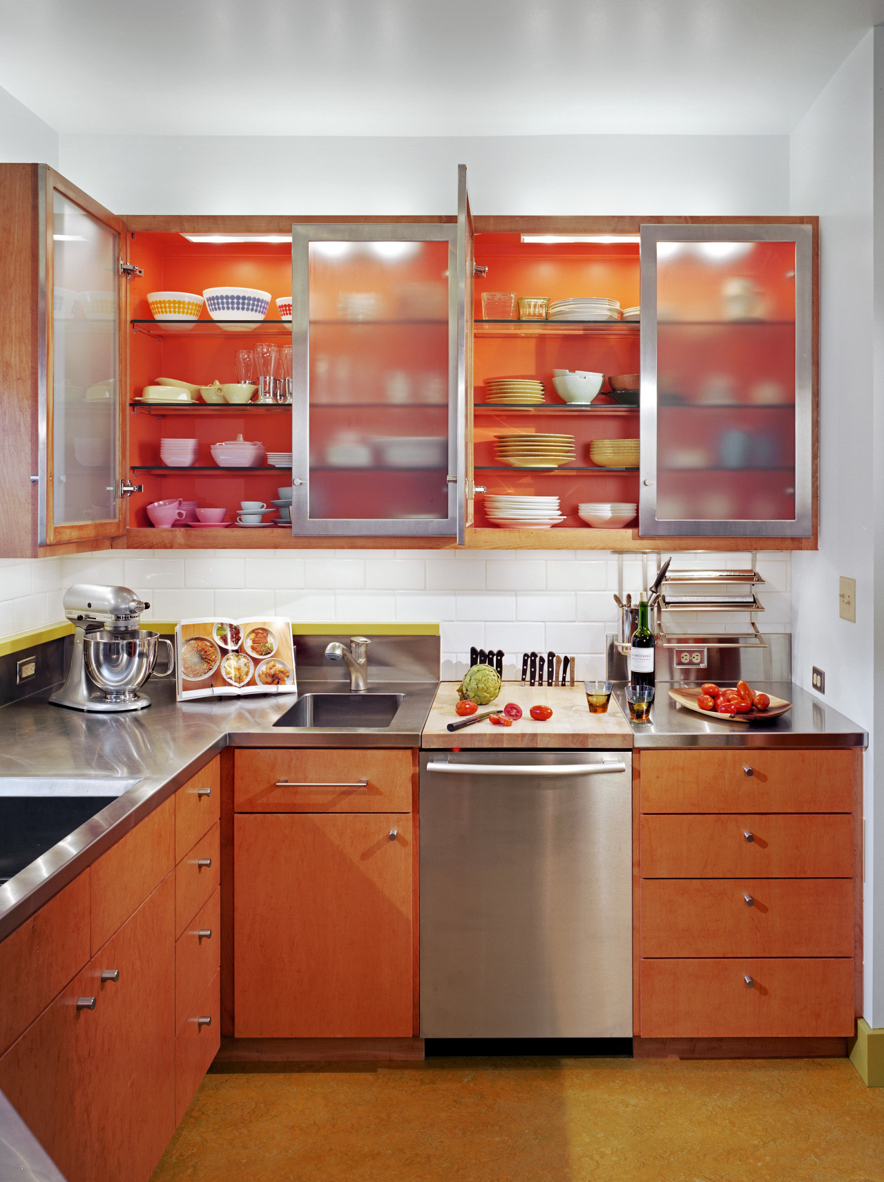 view of kitchen cabinetry, lightng, wooden flooring, sink, cabinetry, countertop, interior design, kitchen, orange, room, shelf, red