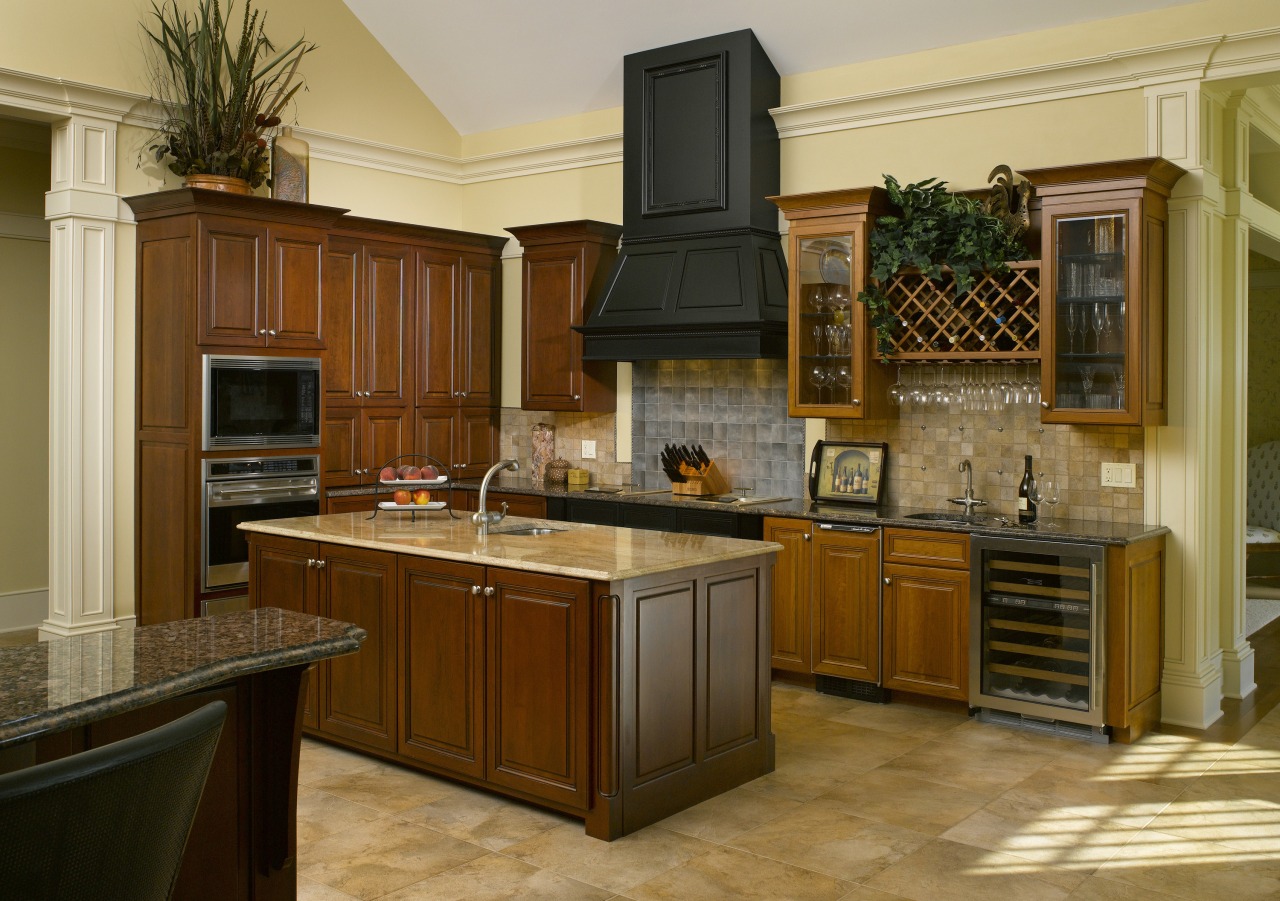 A simple door style and stacked appliances complement cabinetry, countertop, cuisine classique, hardwood, interior design, kitchen, room, brown, orange