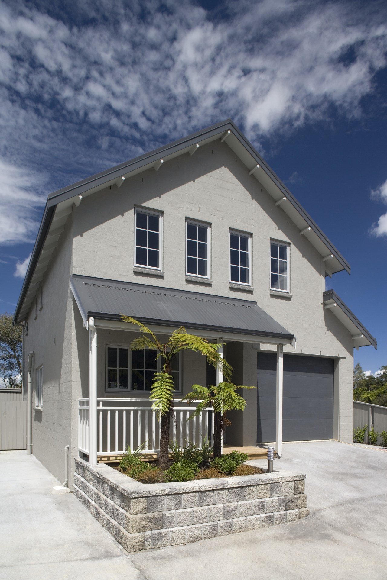 Exterior view of contemporary home created by developer building, cottage, elevation, estate, facade, home, house, property, real estate, residential area, roof, siding, window, gray