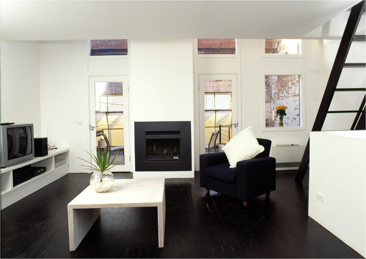 View of a lounge area, with dark flooring, furniture, interior design, living room, room, white, black, gray