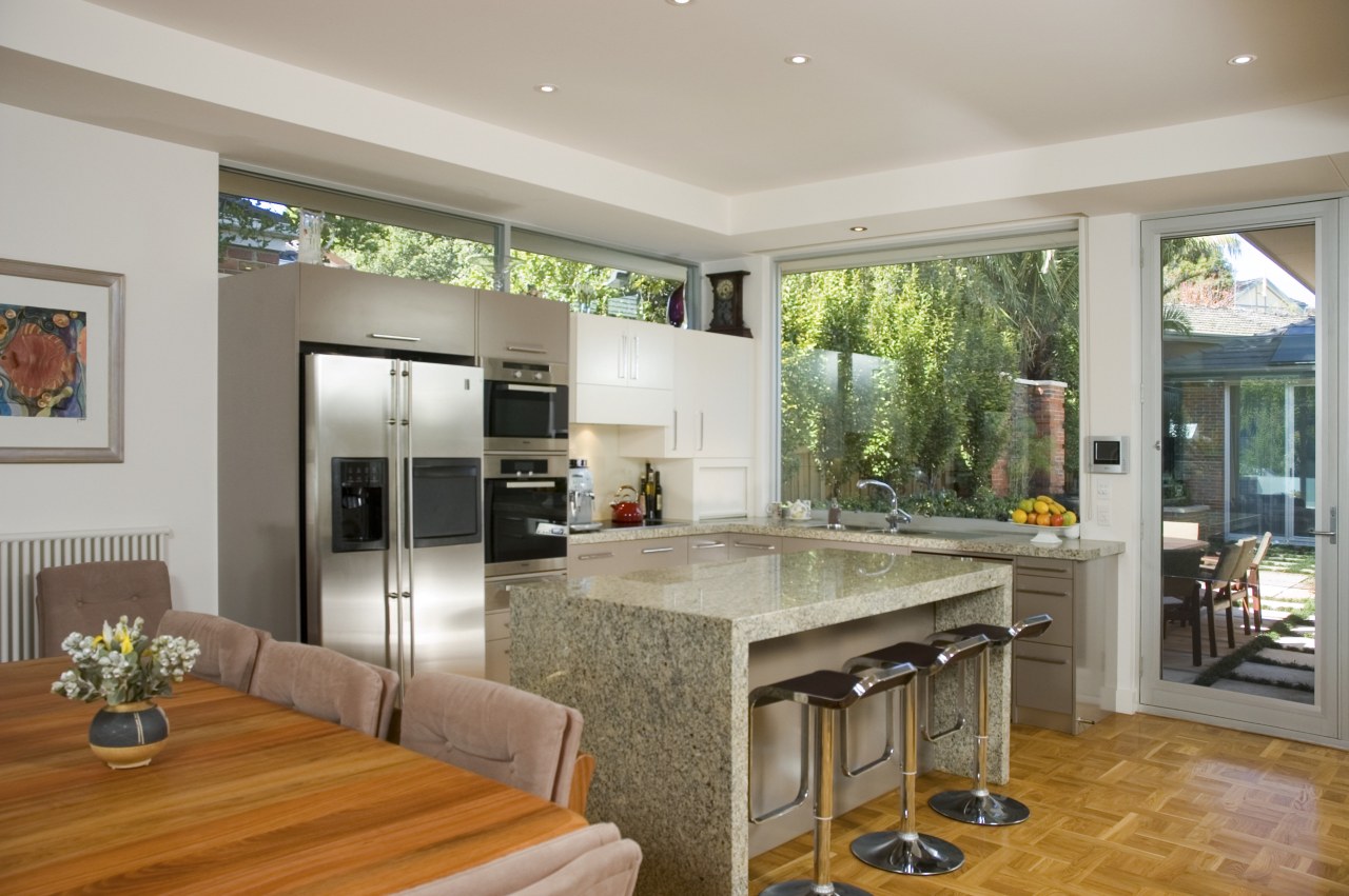 Several rooms, including the kitchen, connect to an countertop, interior design, kitchen, living room, real estate, window, gray, brown