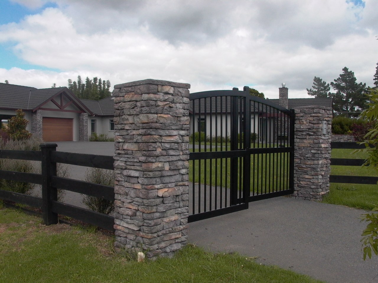 Gate with stutex stone posts estate, facade, fence, gate, home fencing, land lot, outdoor structure, property, real estate, stone wall, white