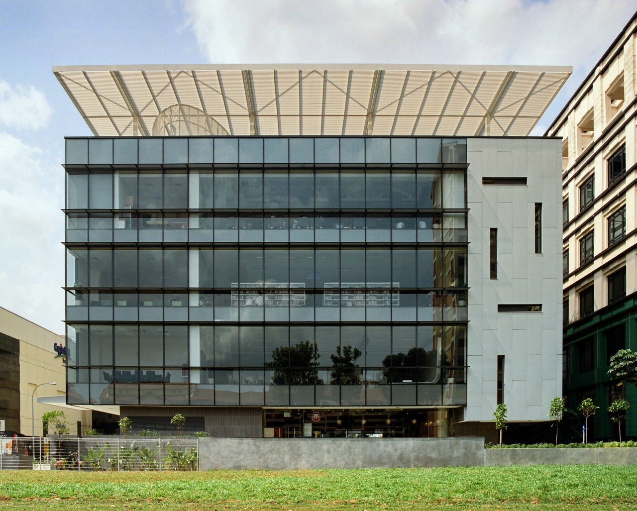 exterior view of the Bishan community Library featuring apartment, architecture, building, commercial building, condominium, corporate headquarters, facade, headquarters, house, mixed use, real estate, residential area, gray