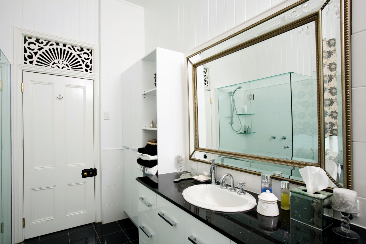 A granite-topped vanity provides generous storage, while mirrors bathroom, home, interior design, room, white, gray