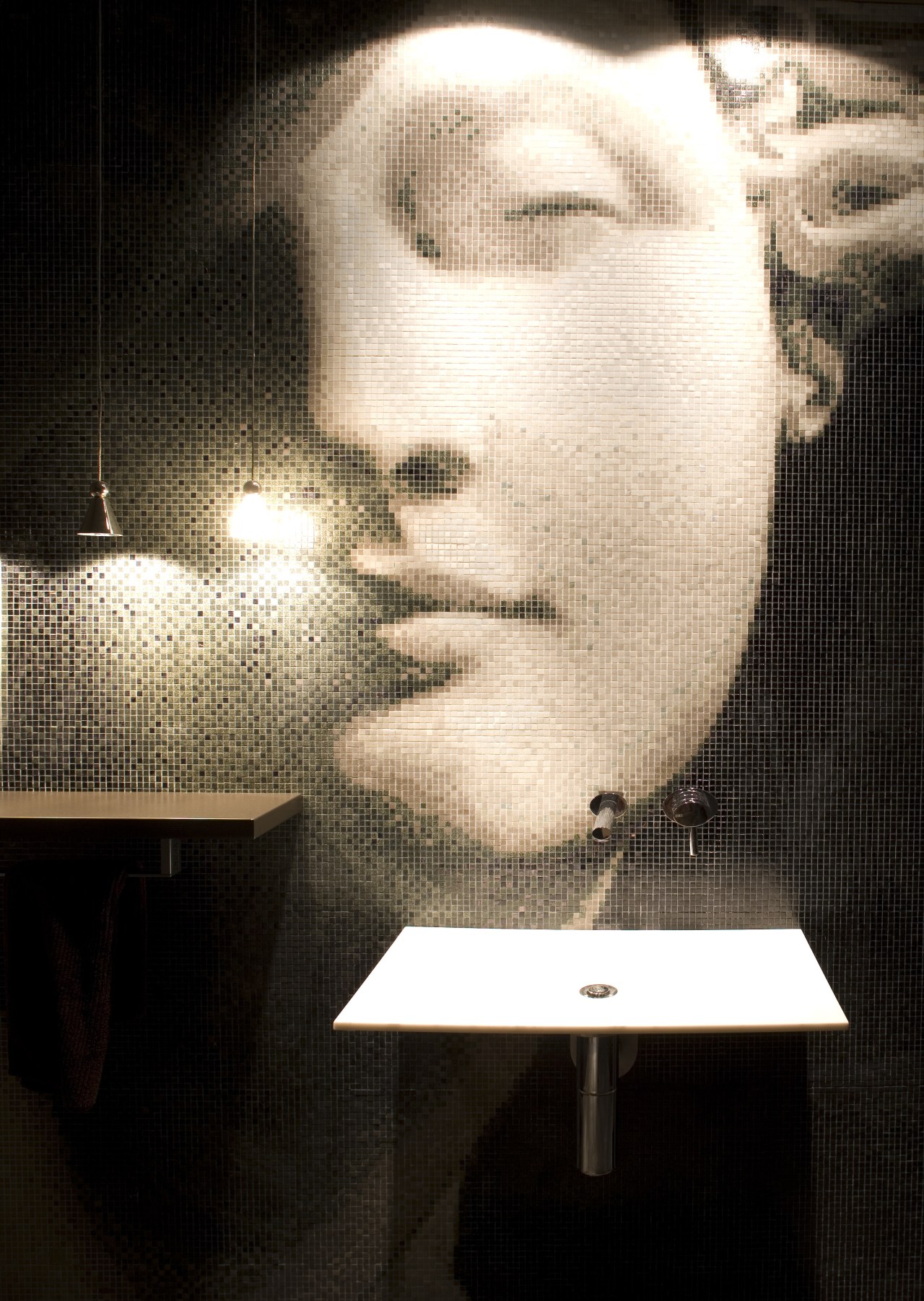 View of a powder room which features a darkness, design, facial hair, lamp, light, light fixture, lighting, shadow, black, white