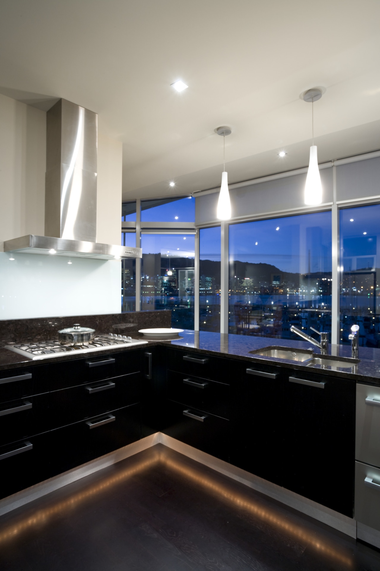 Deep-toned, reflective surfaces give this kitchen an atmospheric architecture, ceiling, countertop, daylighting, interior design, kitchen, lighting, room, gray, black