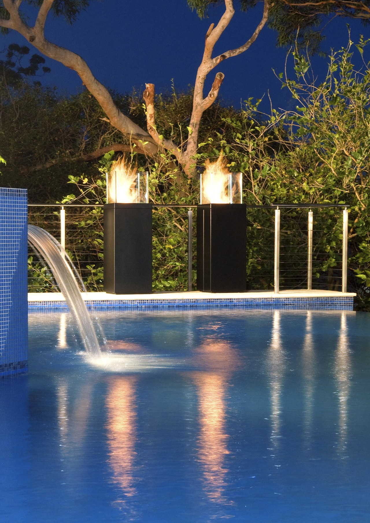 View of new EcoSmart Fire Tower from Real blue, evening, landscape lighting, leisure, light, lighting, reflection, sky, swimming pool, tree, water, water feature, blue, brown